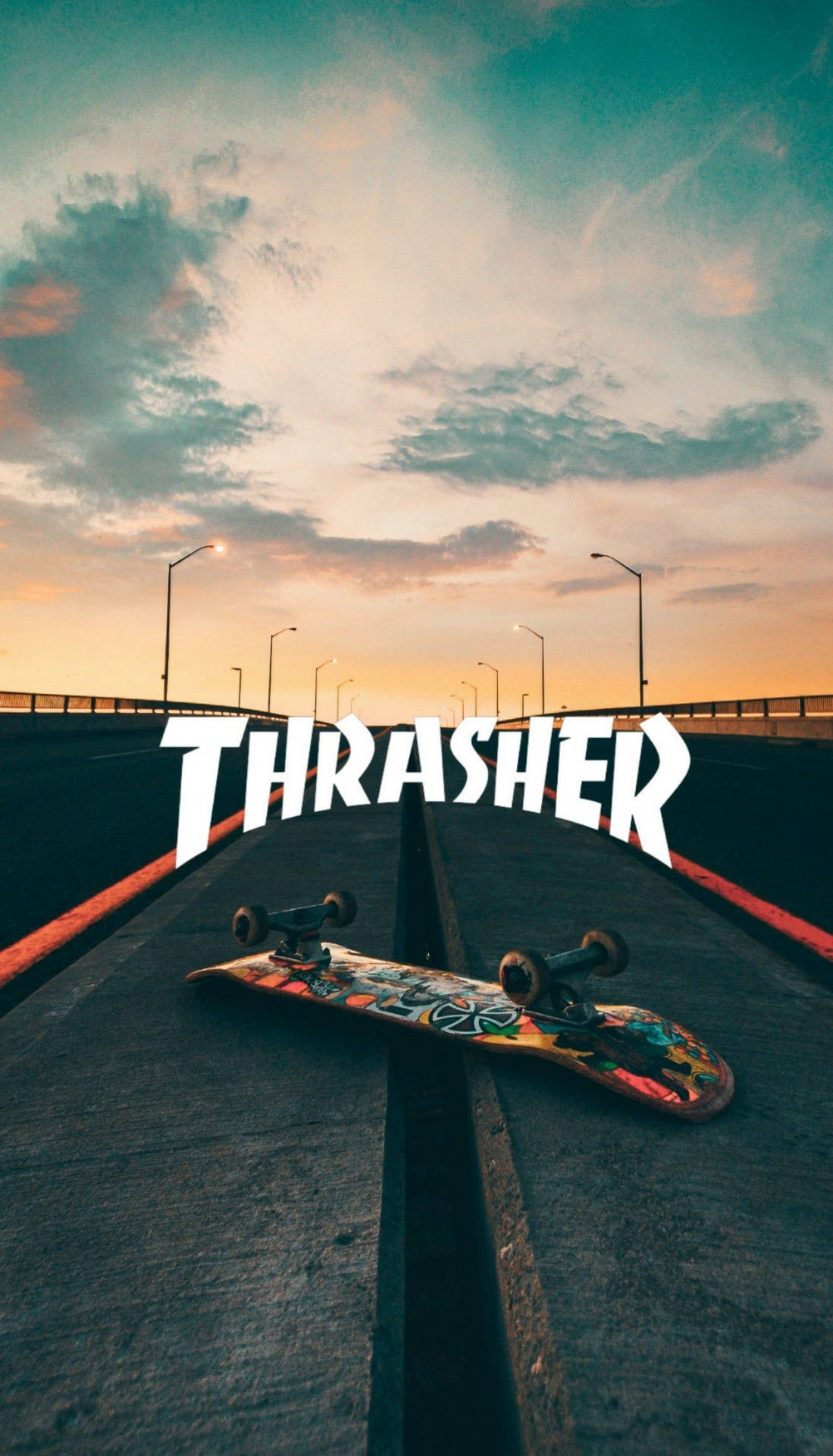 夕陽下橋上的滑板，帶有 THRASHER 標誌