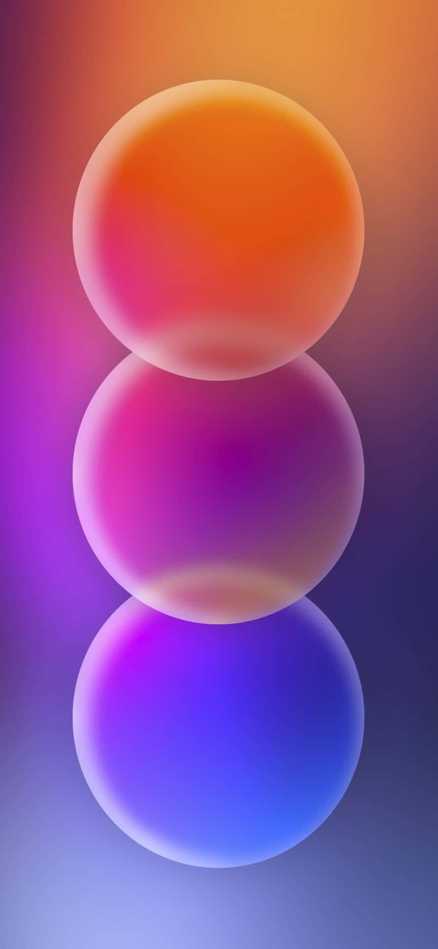  壁紙 — 三個發光的半透明球體垂直漂浮在從暖橙色到冷紫色的漸變背景上。