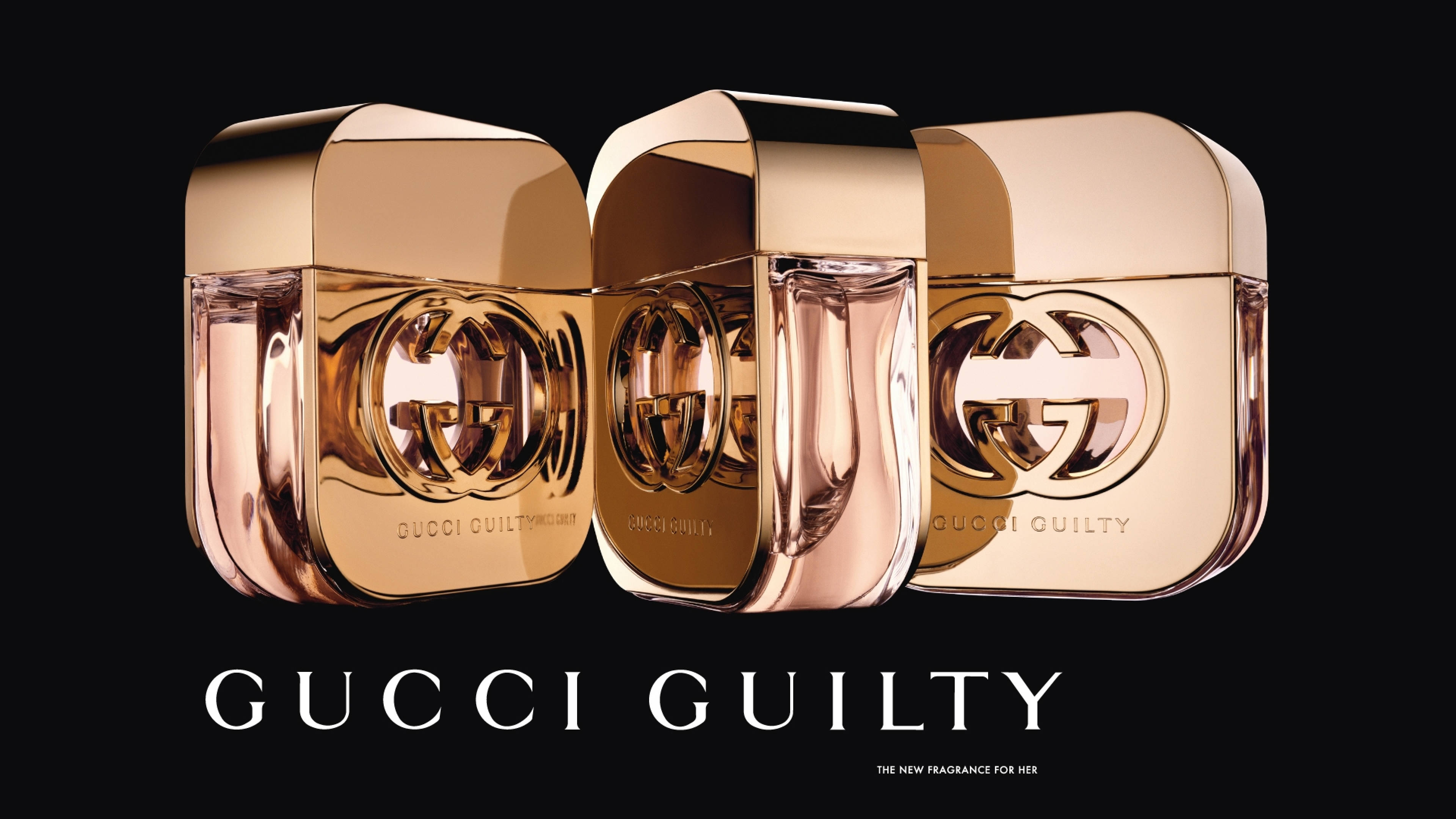 三支Gucci Guilty香水瓶，帶玫瑰金瓶蓋和黑色背景。