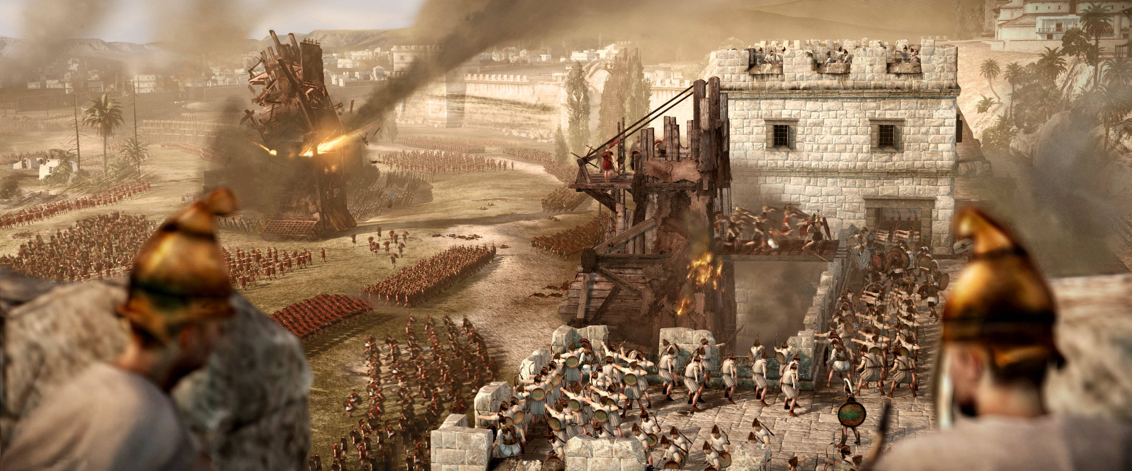 Total War 大規模入侵 壁紙 — 古代士兵在塵土飛揚的戰場上，用攻城塔和燃燒彈攻擊石頭堡壘。