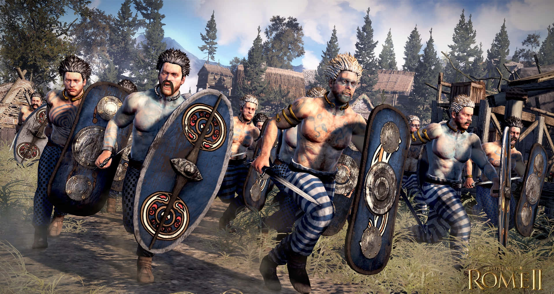 《Total War：羅馬2》最佳背景——盾牌版 壁紙 — 一群肌肉發達的古代戰士穿著條紋褲和華麗盾牌，在晴朗的天空下衝過一個有木屋和松樹的鄉村。