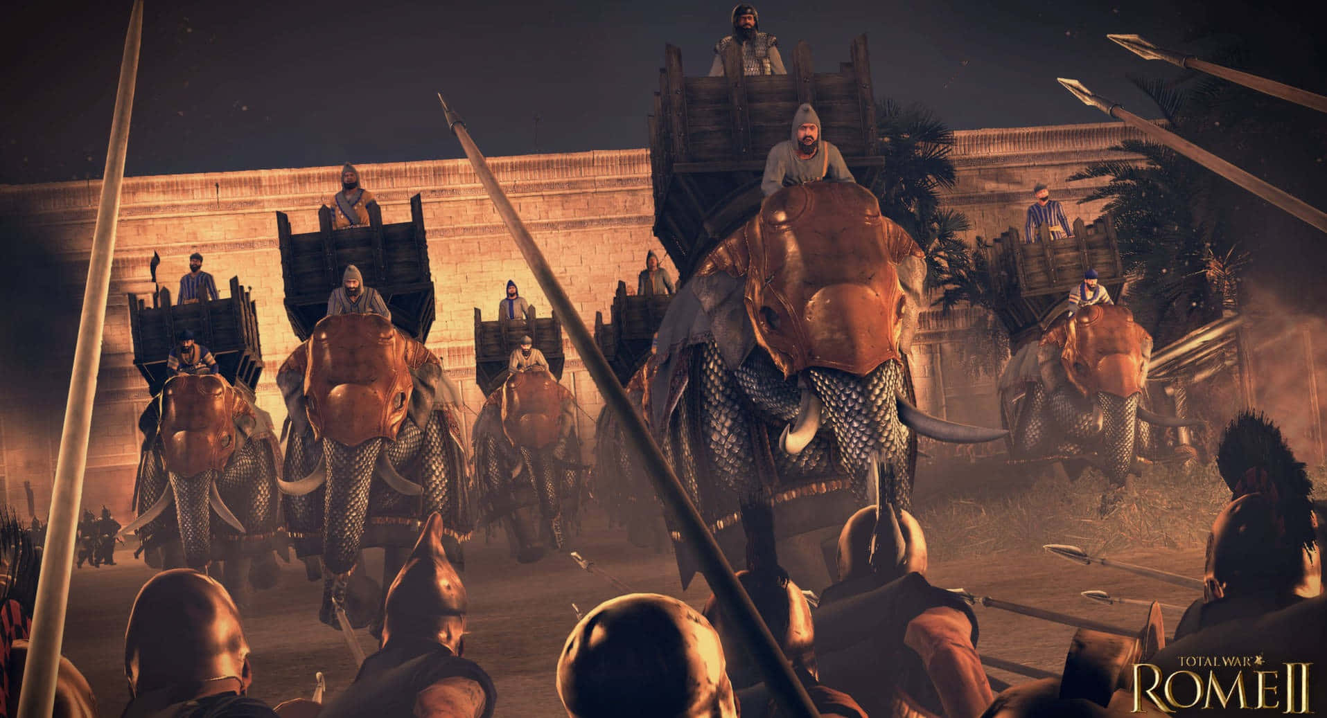 《Total War：羅馬2》最佳陣營戰場背景：夜戰象兵 壁紙 — 裝飾華麗的戰象在火把照耀下，與揮舞長矛的士兵一起，在塵土飛揚的夜間戰場上衝鋒。