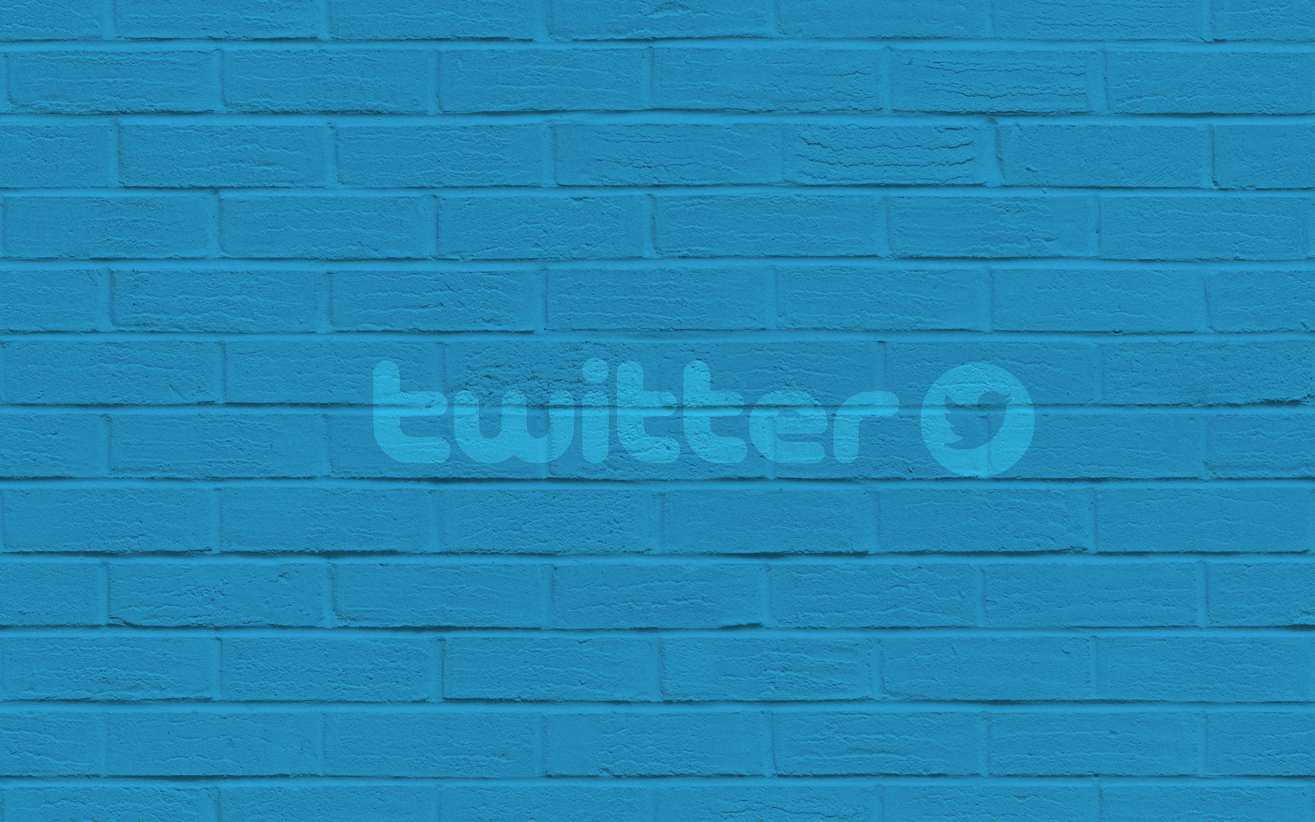 Twitter磚牆壁紙 壁紙 — 一面充滿活力的藍色油漆磚牆，中間有一個褪色的twitter標誌。