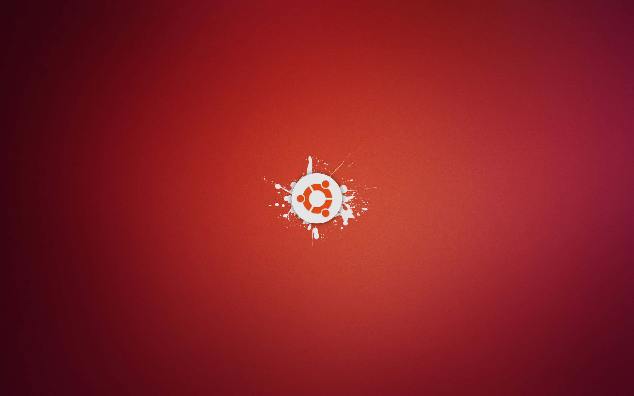 與 Ubuntu 一起探索無限可能 壁紙 — Ubuntu 標誌在漸變紅色背景上濺上白色油漆。