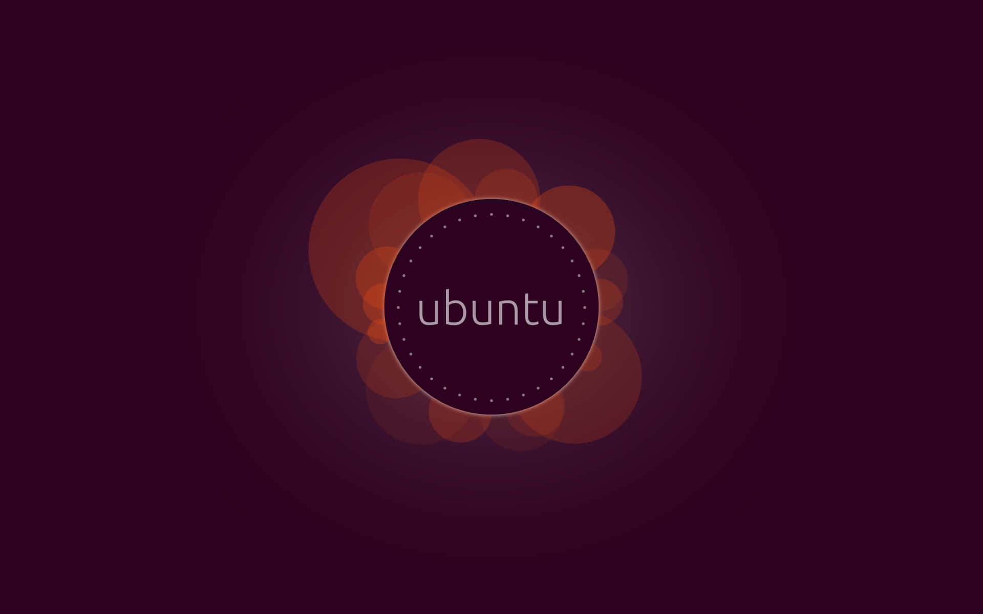 Ubuntu 標誌在深紫色背景上帶有橙色散景圓圈。