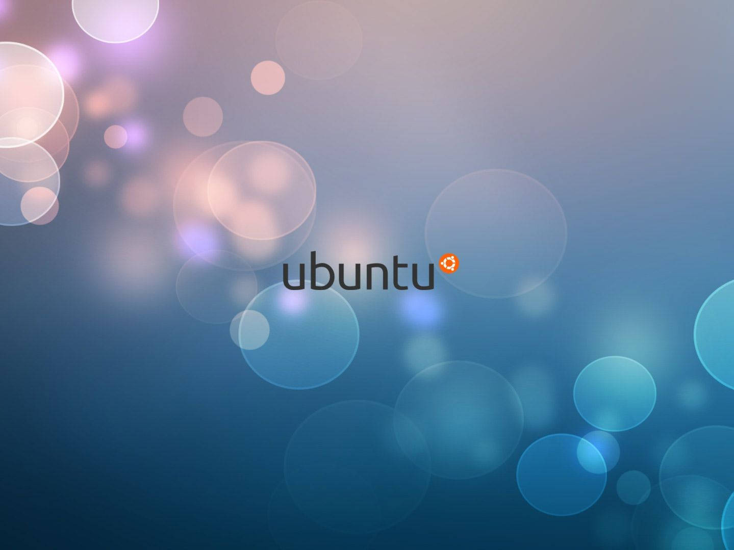 Ubuntu 標誌在藍色漸變背景上帶有發光的散景燈光。