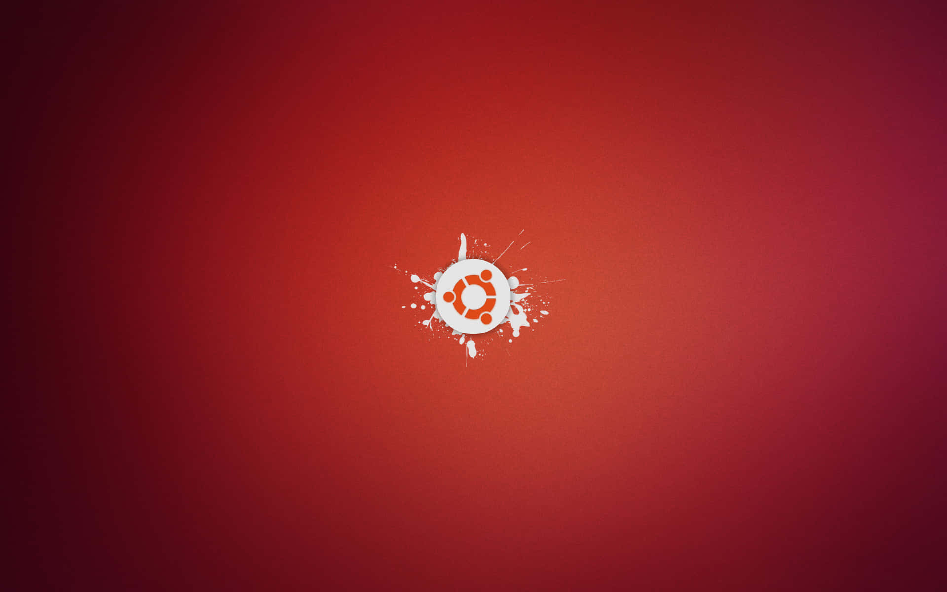 Ubuntu 標誌在紅色漸變背景上有白色油漆濺灑。