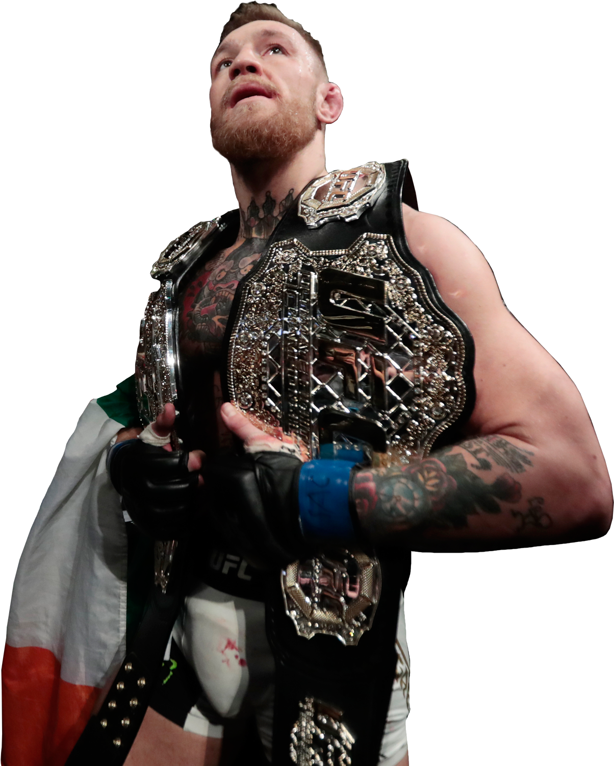 康納·麥格雷戈UFC冠軍姿勢 壁紙 — Conor McGregor 勝利地站立，手持UFC冠軍腰帶，愛爾蘭國旗披在肩上，背景為黑色。