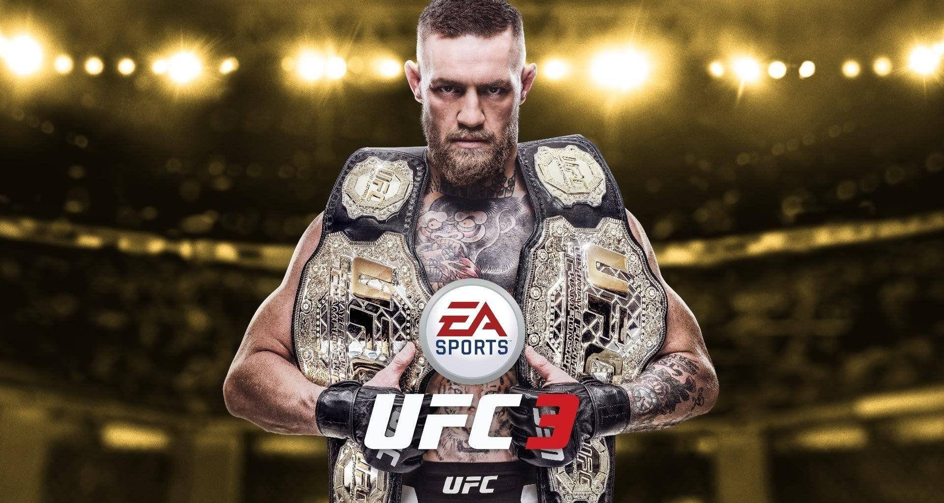 UFC 雙冠王激戰瞬間 壁紙 — Conor McGregor 在明亮的場館燈光下，手持多條UFC冠軍腰帶，眼神專注。