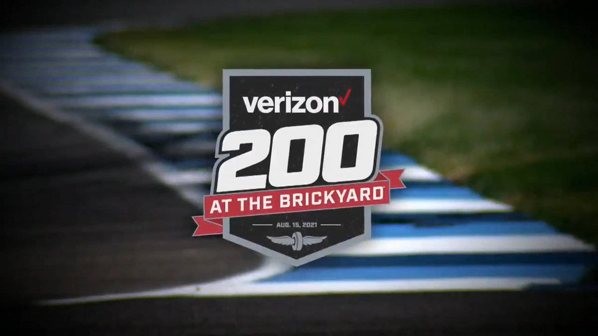 Verizon 200 賽道 Brickyard 壁紙 — 一個清晰的Verizon 200在磚廠賽事標誌疊加在模糊的賽道上，帶有藍色和白色的路緣。