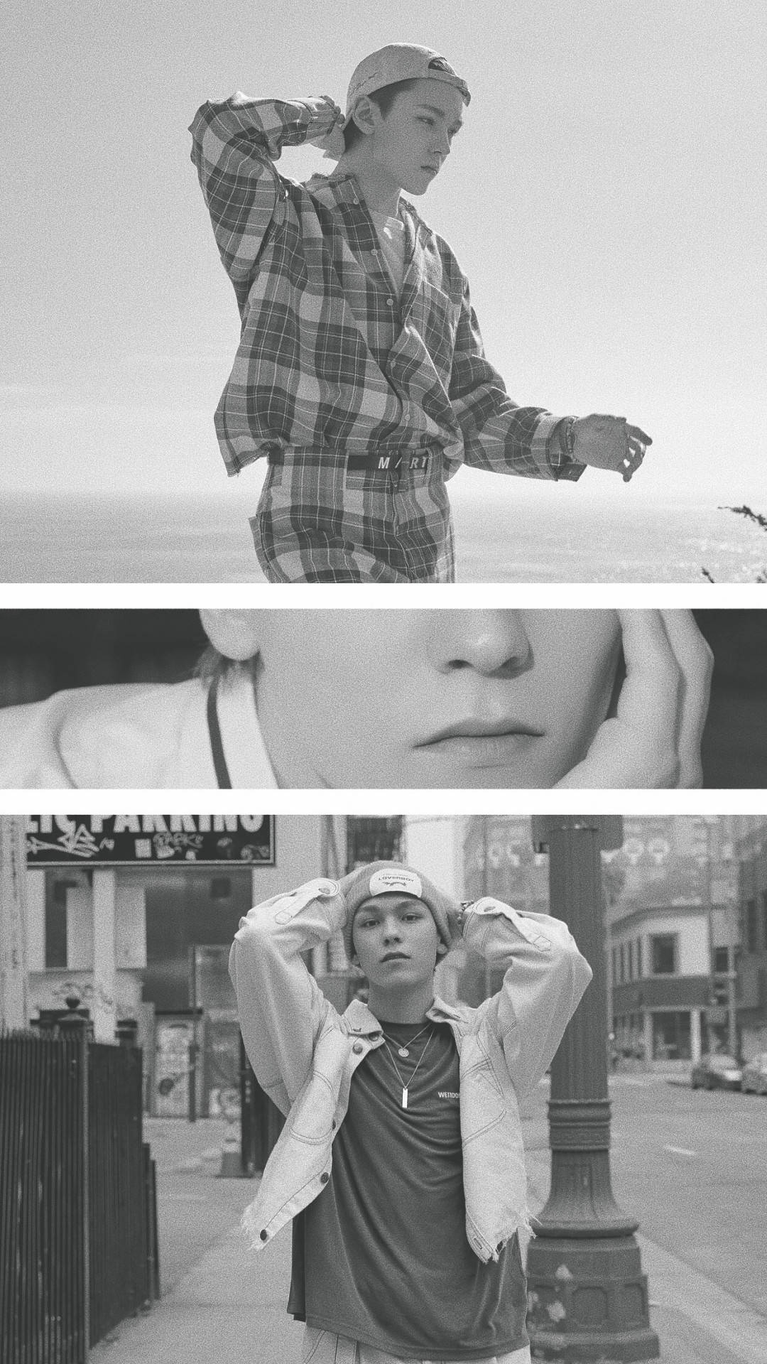 Vernon 在 Snap Shoot MV 中 壁紙 — 一位身穿格仔衫和帽子的年輕男子，在明亮的天空和城市街道背景下，以黑白風格自信地擺姿勢。