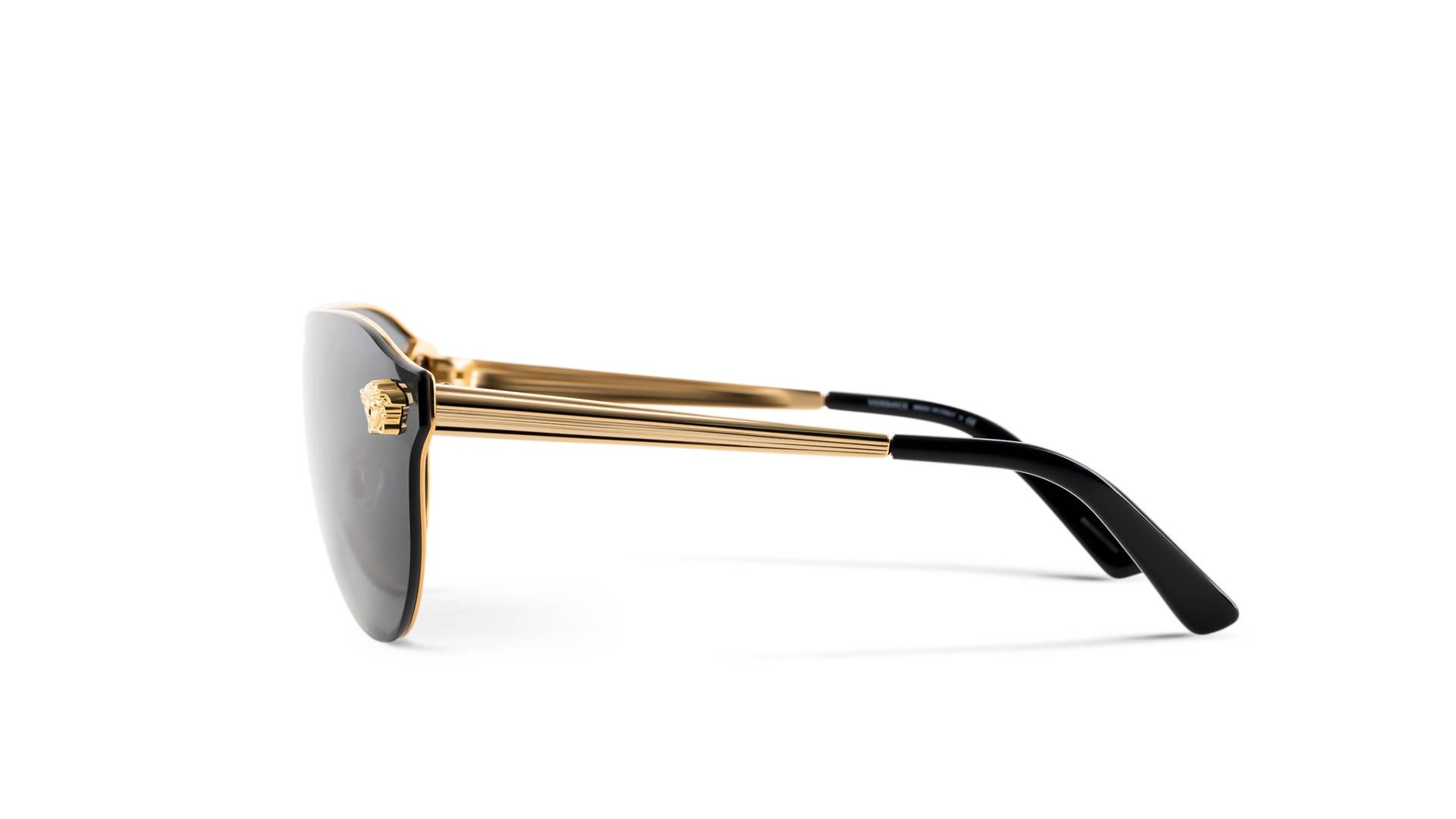 Versace Aurinkolasit VE 2161 1002/F9太陽眼鏡 壁紙 — 白色背景上，金色鏡框、黑色鏡片及標誌性頭部標誌的奢華太陽眼鏡側面輪廓。