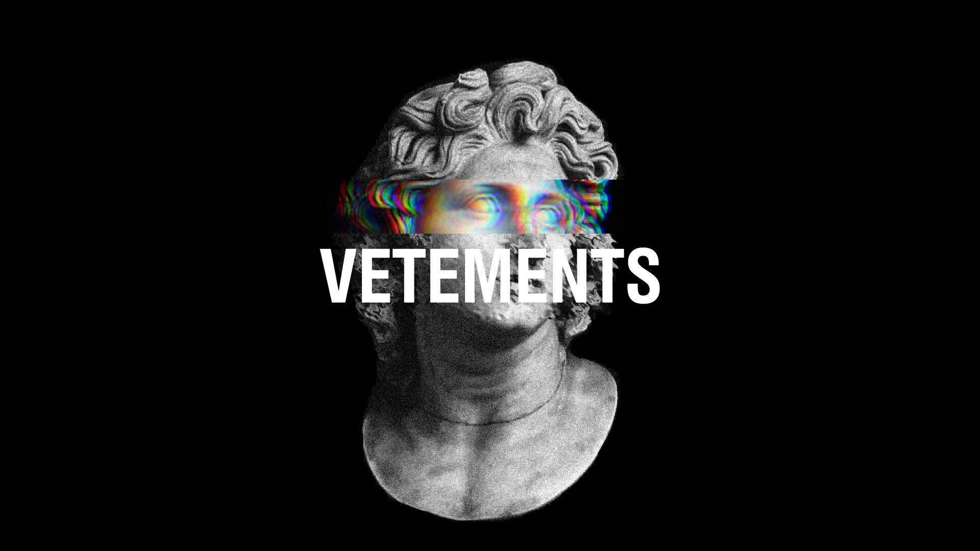 Vetements經典雕塑 壁紙 — 經典大理石半身像，帶有故障彩虹眼睛和粗體白色 VETEMENTS 文字，背景為黑色。