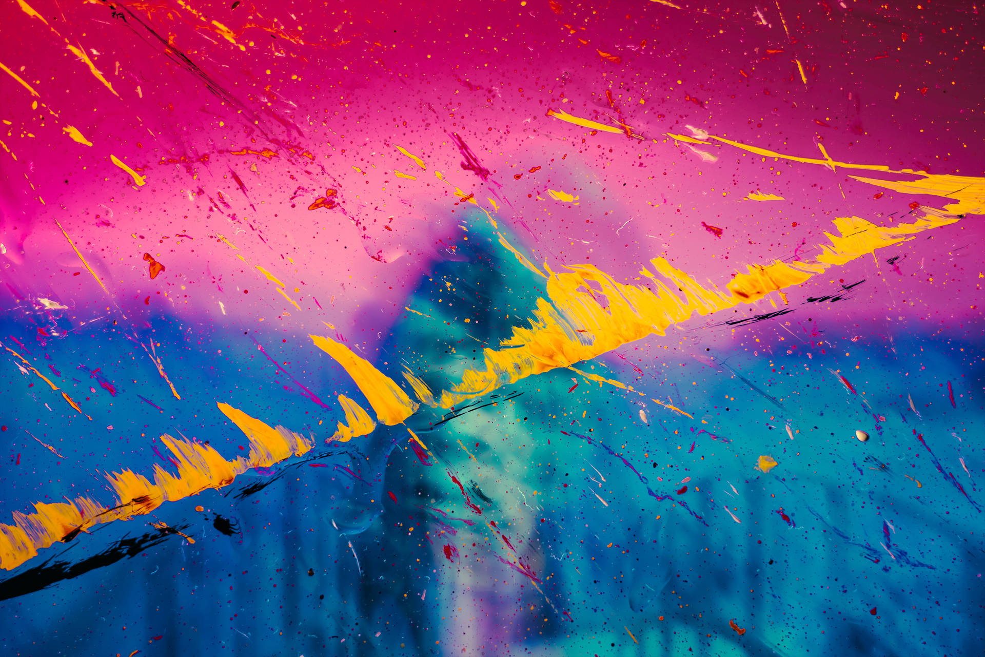 大膽的抽象顏料潑濺，帶有洋紅色、藍色和黃色條紋。