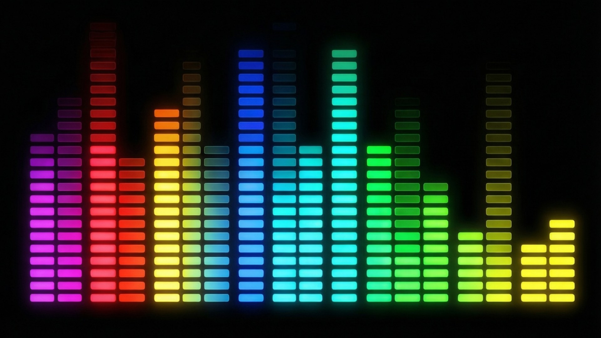 Spectrum Equalizer 壁紙 — 充滿活力的彩虹色音頻均衡器條在黑色背景上發光，脈動著數位能量。
