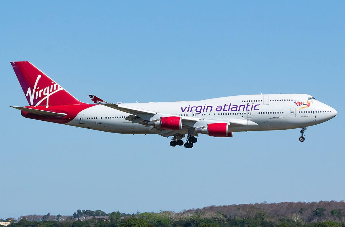 維珍航空波音747飛機起落架放下，在藍天中降落。