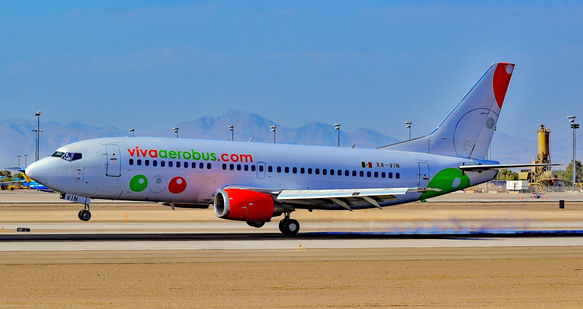 Viva Aerobus飛機在機場跑道上滑行，背景有山。