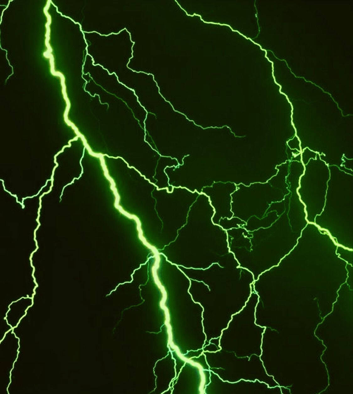 綠色閃電叉照亮了黑暗的暴風雨天空。
