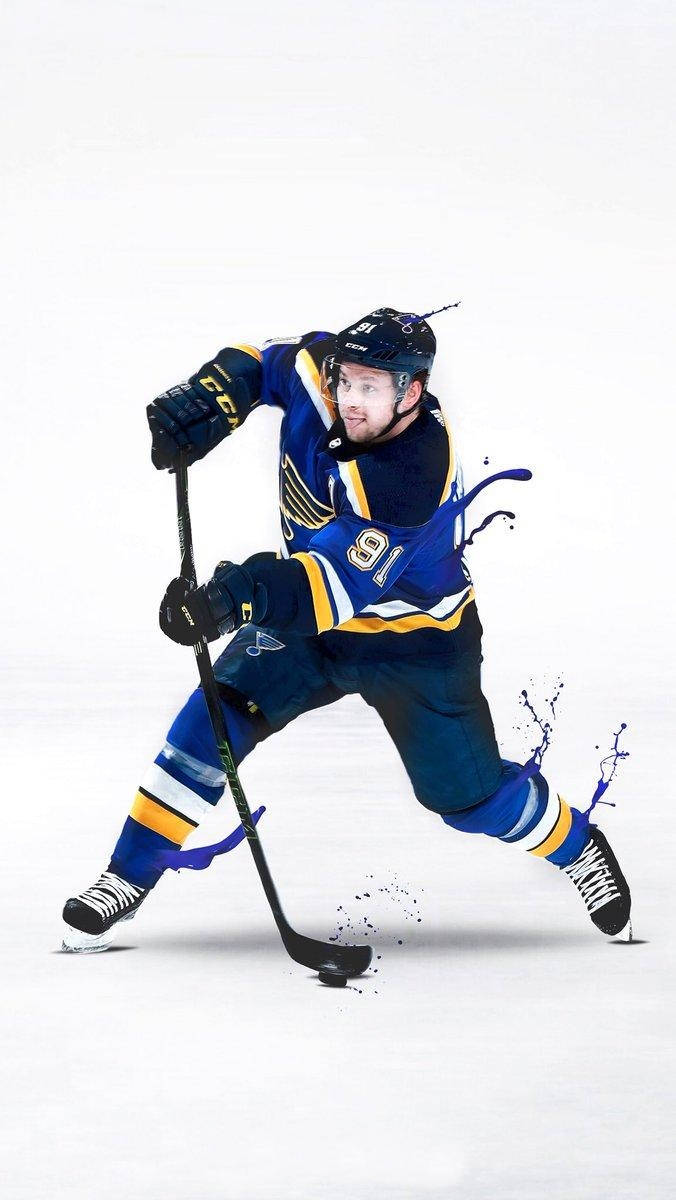 Vladimir Tarasenko dribble冰球與噴漆效果 壁紙 — 一名身穿藍色和金色球衣的冰球運動員在冰上動態滑行，溜冰鞋周圍有油漆飛濺效果。
