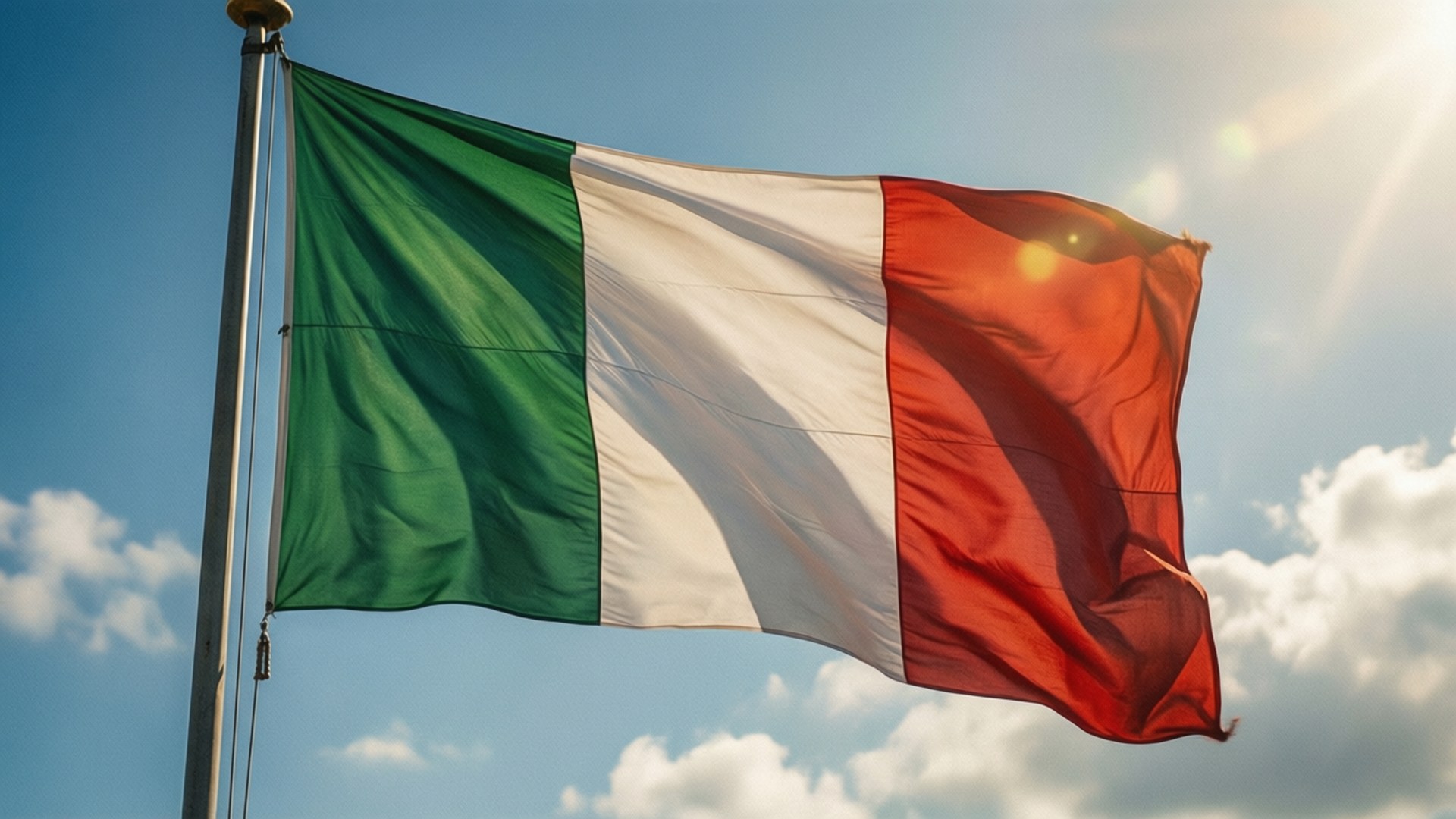 Italian flag flying in the wind against a sunny sky with clouds. 壁紙