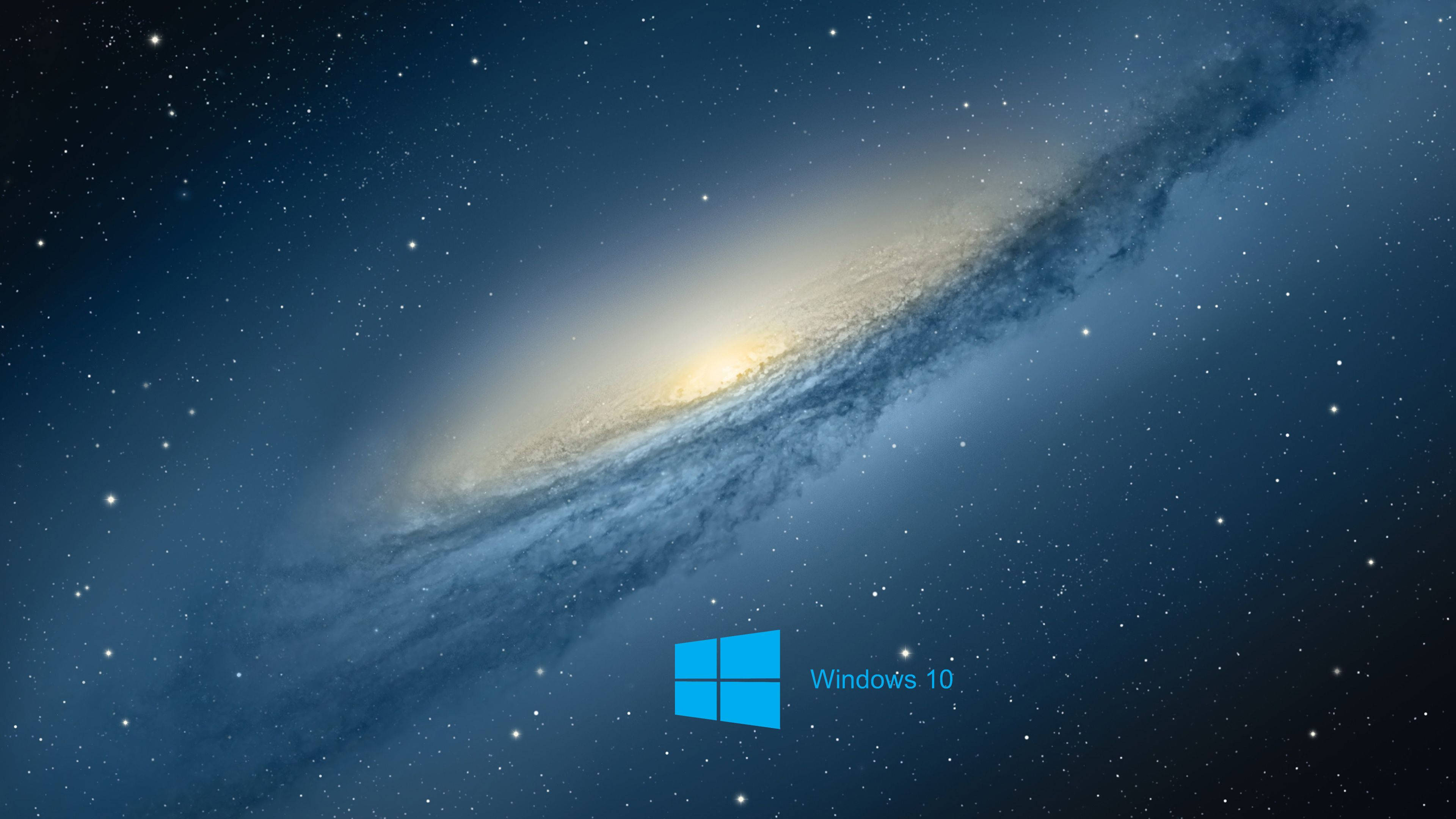 Windows 10 星際主題 壁紙 — 一個雄偉的螺旋星系，帶有發光核心和旋轉的塵埃帶，以星空為背景，並帶有Windows 10標誌。