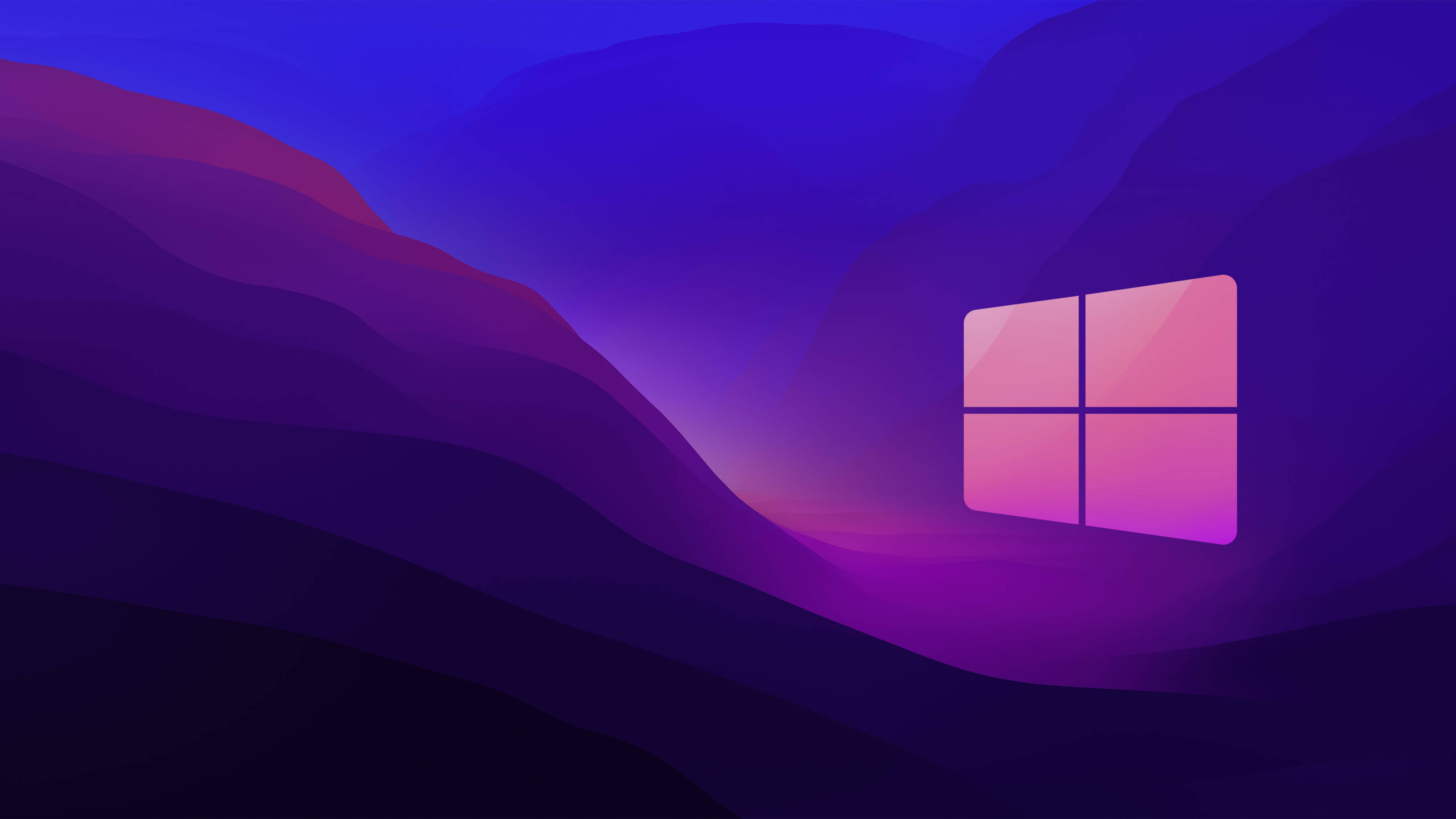 Windows 10 紫色漸層山脈 壁紙 — 一個發光的Windows標誌漂浮在風格化的紫色山谷中，天空呈現漸變色。