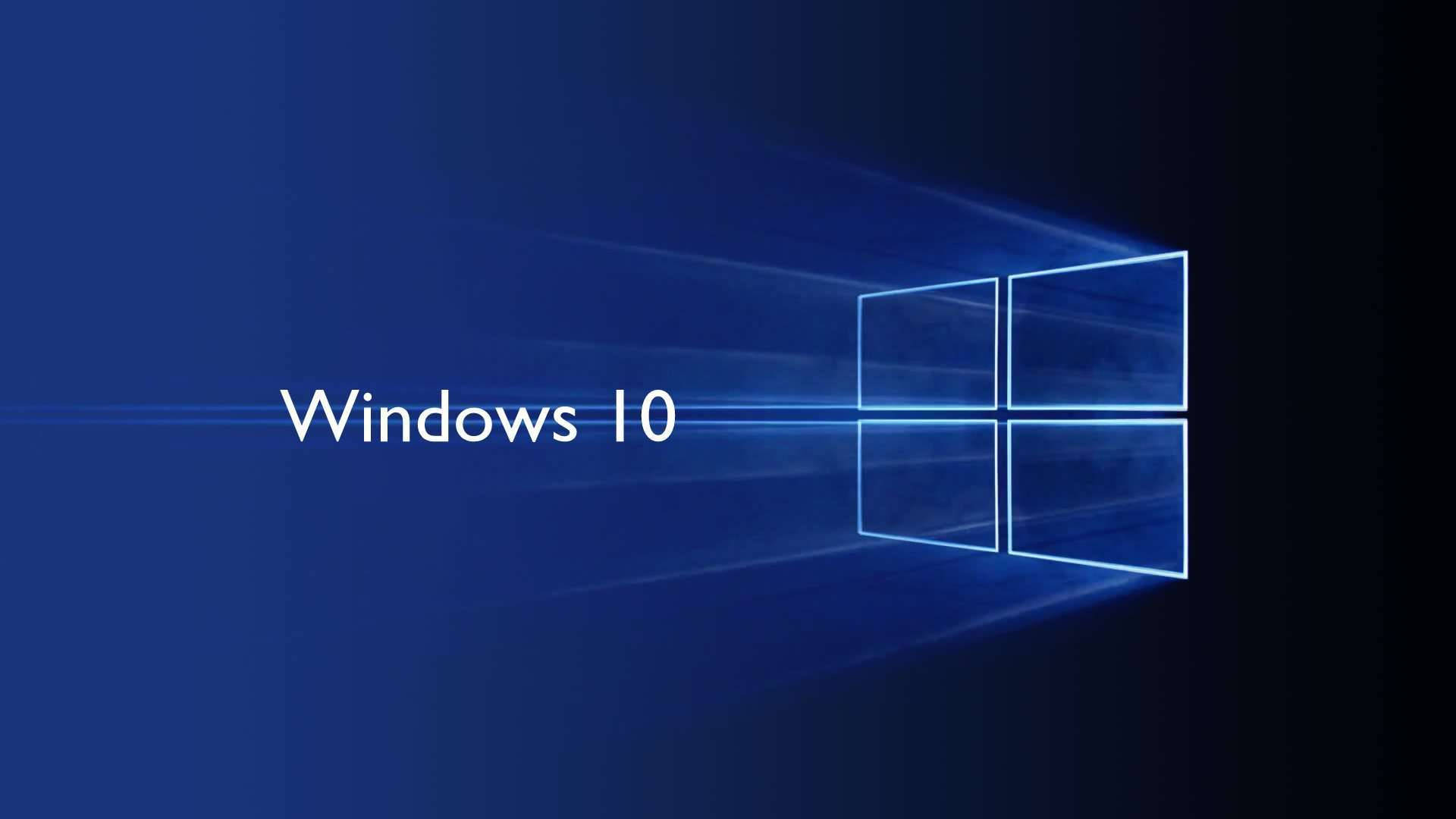 Windows 10 高清深色漸層 壁紙 — Windows 10 標誌在深藍色漸變背景上發出藍色光芒。