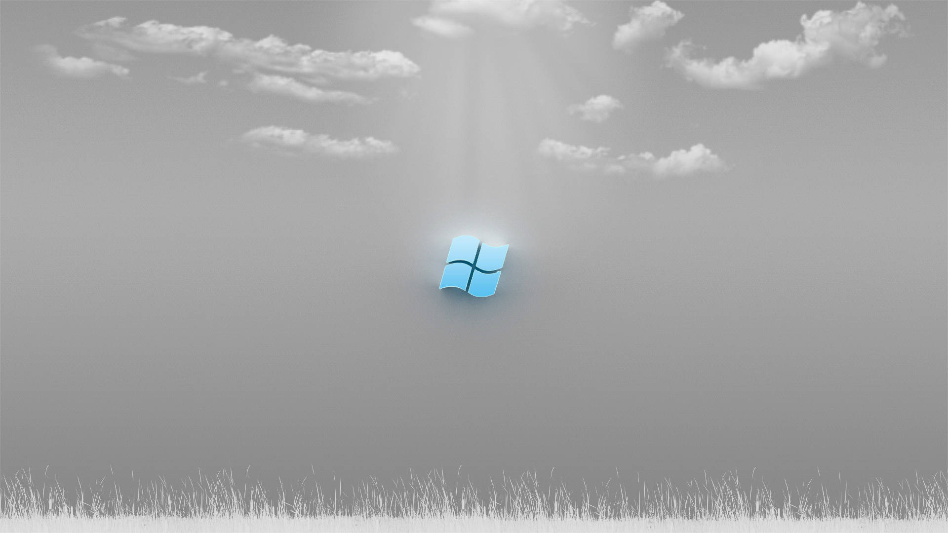 Windows 10 高清灰雲天空 壁紙 — 一個發光的藍色Windows標誌漂浮在單色天空中，下方是草地，陽光穿過雲層照射下來。