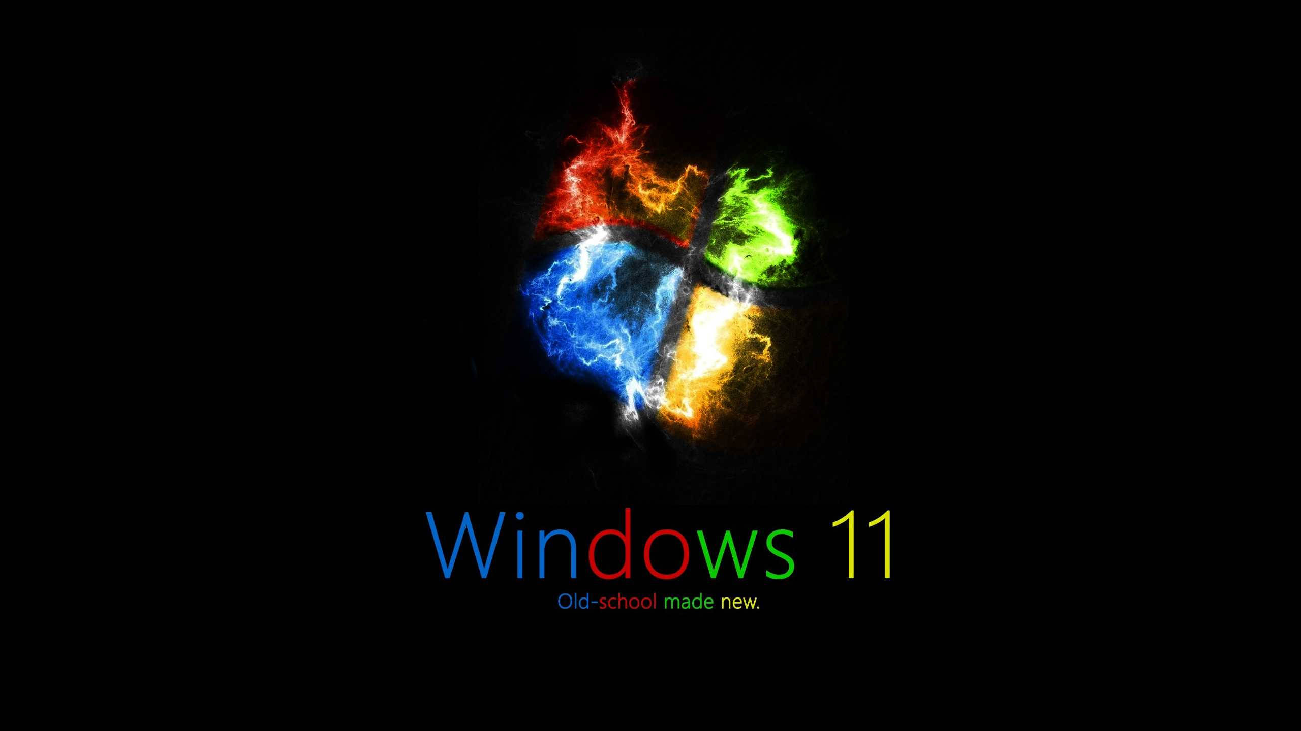 Windows 11 4K 燃燒標誌 壁紙 — Windows 11 標誌在黑色背景上迸發出火紅、綠、藍、黃的能量，下方有標語。