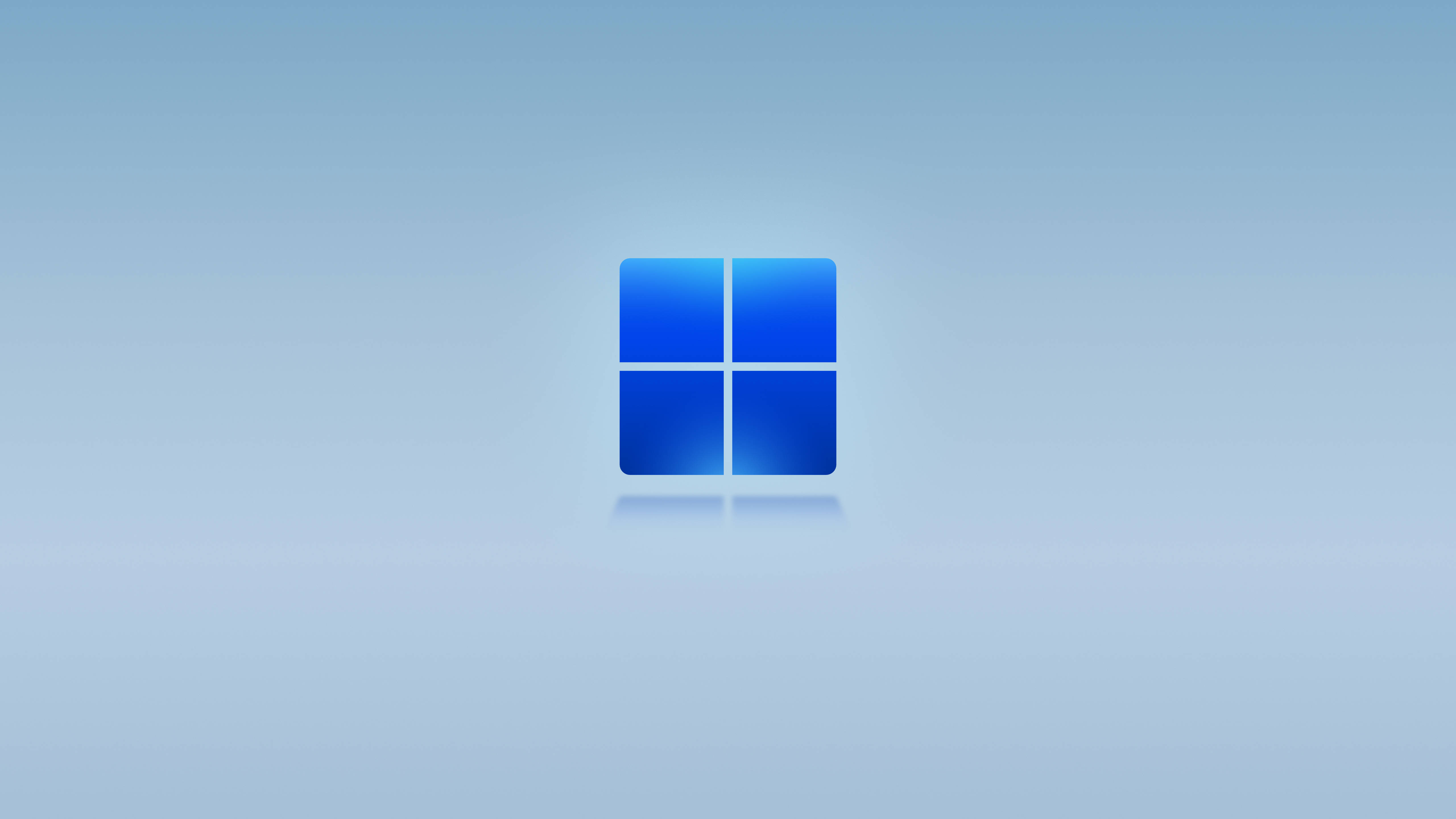 原版 Windows 11 藍色 壁紙 — 一個發光的藍色Windows標誌，居中放置在柔和漸變背景上，帶有微妙的反射。
