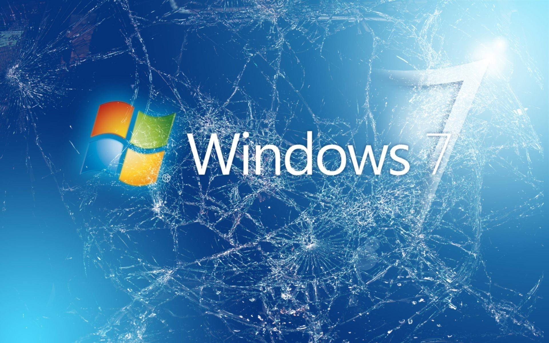 Windows 7 桌布 壁紙 — Windows 7 標誌透過破碎的玻璃閃耀，背景為亮藍色漸變。