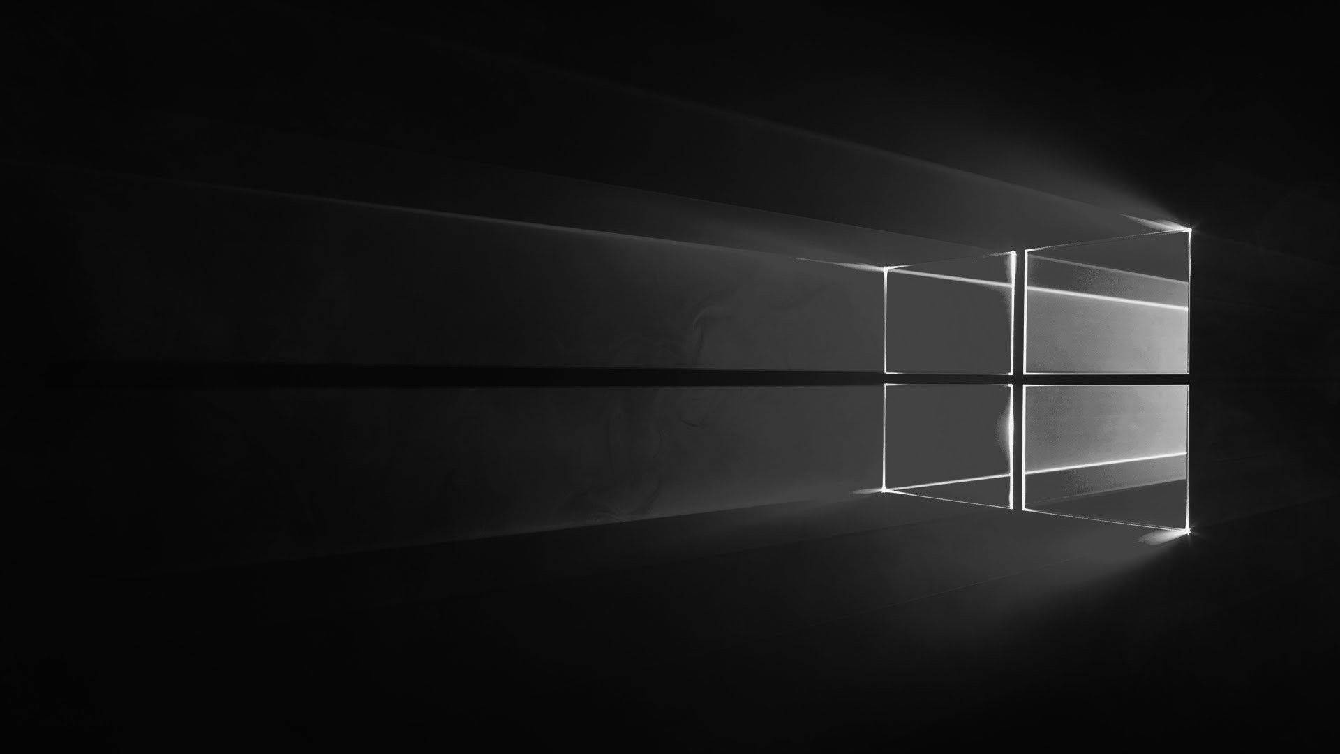Windows 黑色標誌 壁紙 — 一個極簡的黑白窗戶標誌，在黑暗虛空中被戲劇性的光線照亮。