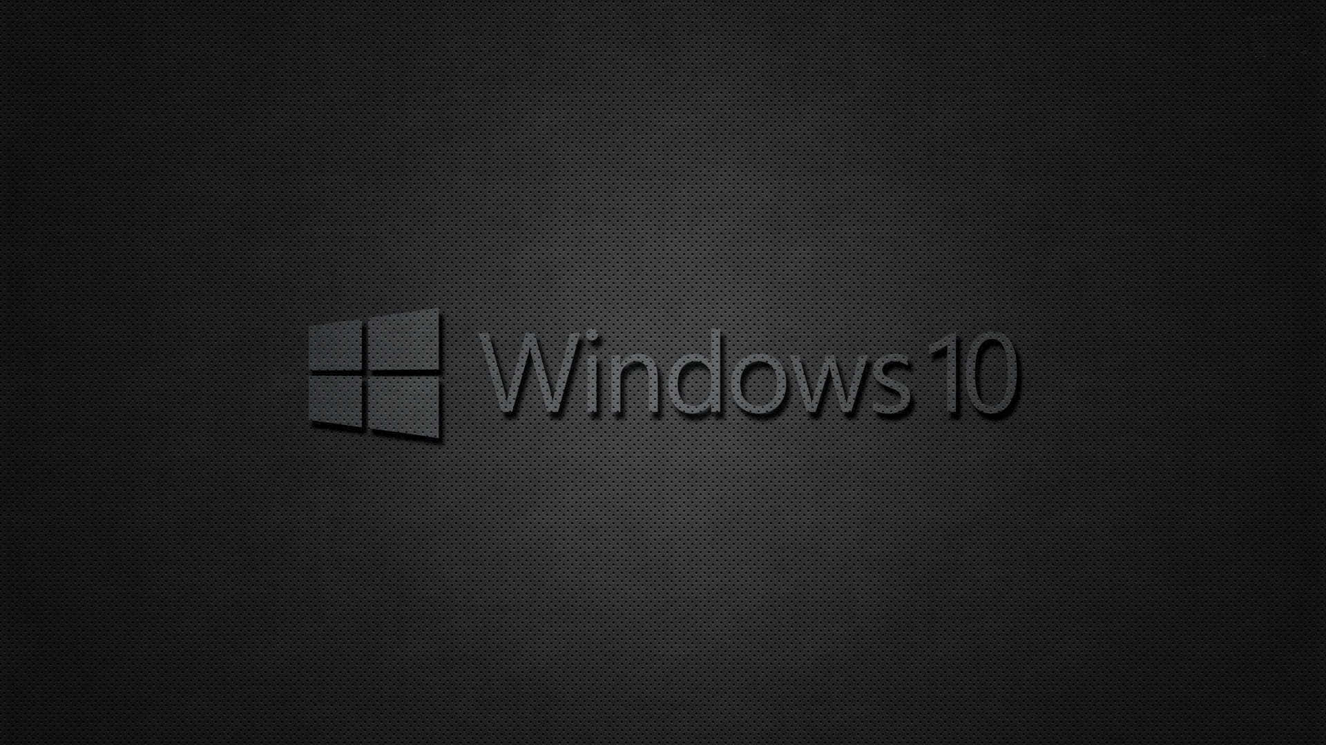 黑色 Windows 桌面主題 壁紙 — Windows 10 標誌居中於帶有微妙漸變照明的深色紋理背景上。