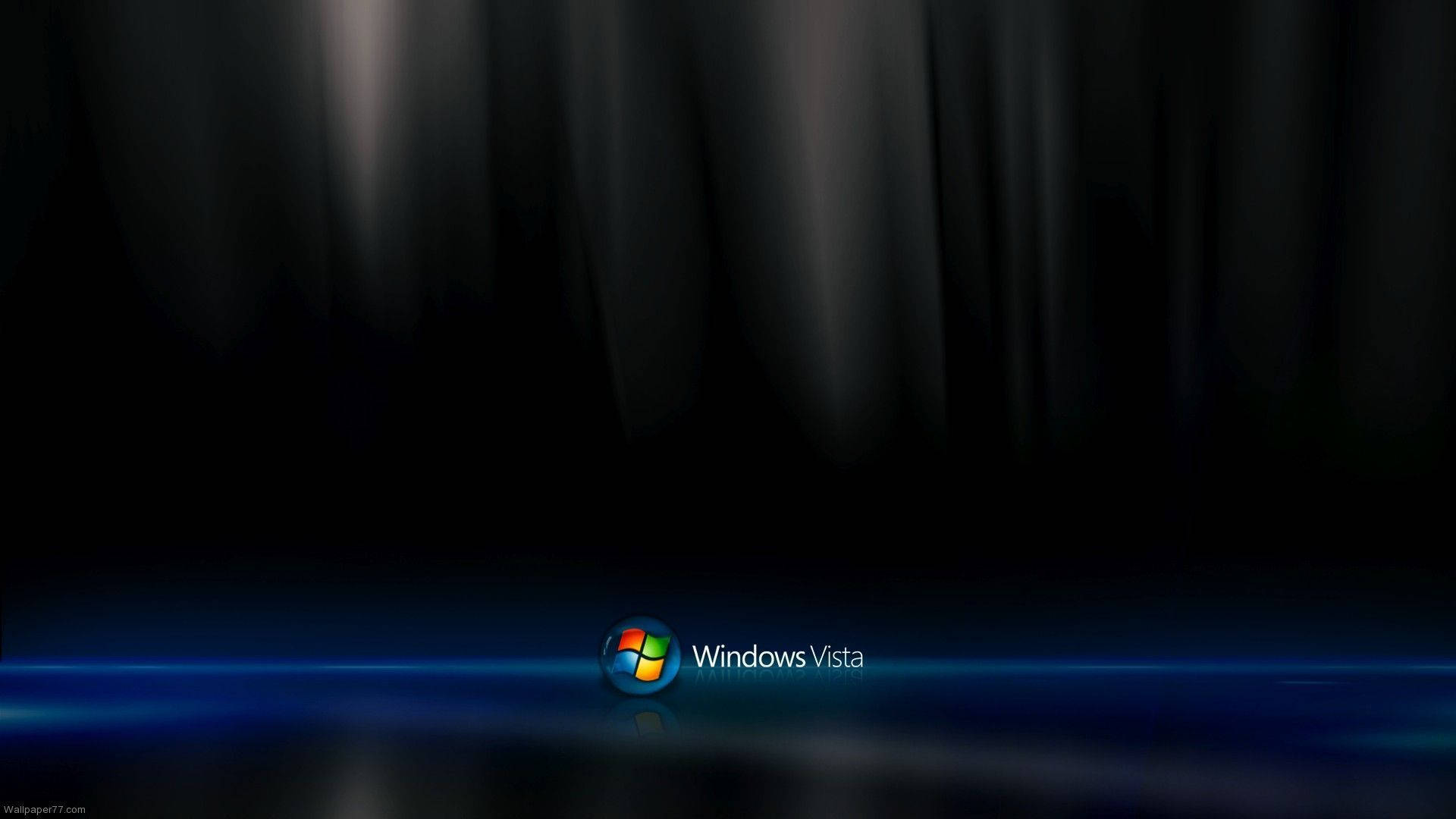 Windows Vista 暗調主題 壁紙 — Windows Vista 標誌在類似窗簾的深色背景上發出藍光。