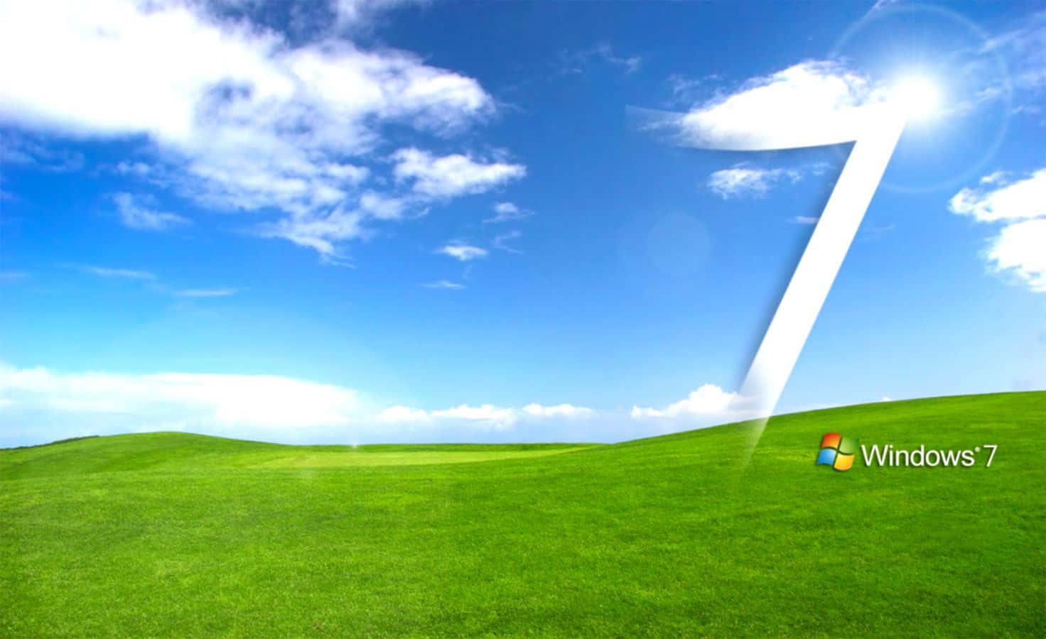 Windows 預設壁紙 壁紙 — 明亮的藍天上有蓬鬆的雲朵，飄浮在起伏的綠色山丘上，前景有一個巨大的白色數字七和Windows 7標誌。