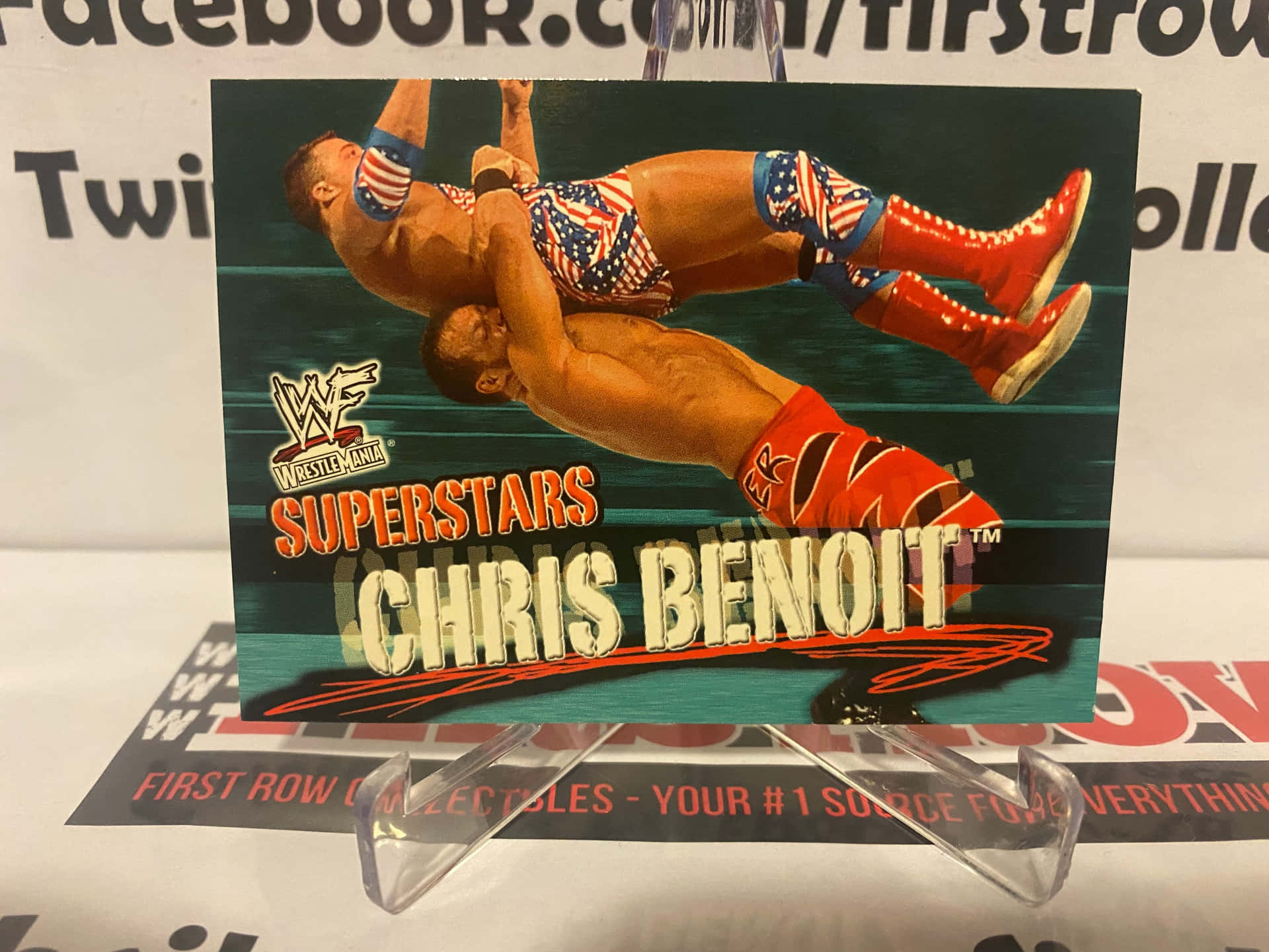 WWE摔角卡，顯示Chris Benoit表演高飛動作。