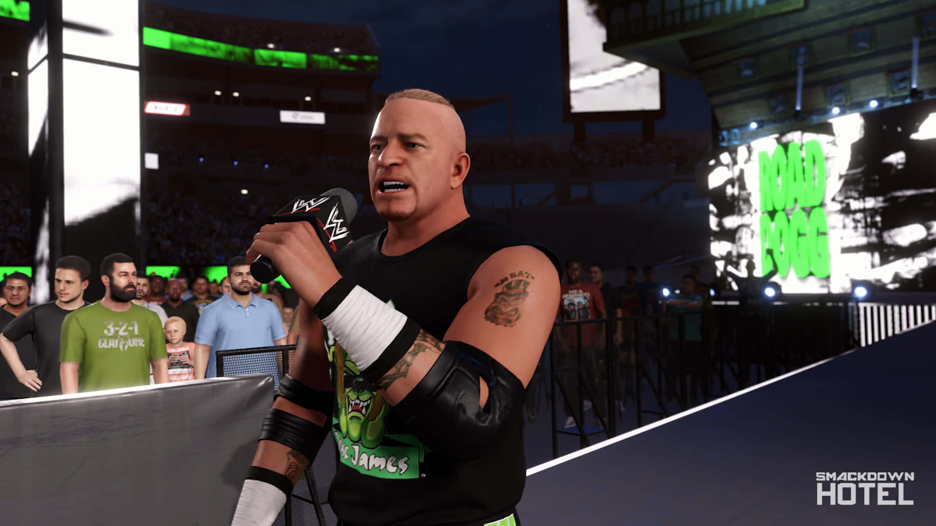 WWE遊戲中的Road Dogg 壁紙 — 摔角手Road Dogg在明亮的場館燈光下，於WWE SmackDown Hotel活動中對著麥克風說話。