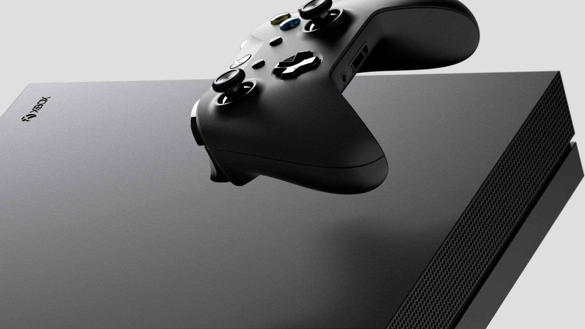 黑色Xbox主機連控制器放在灰色背景上