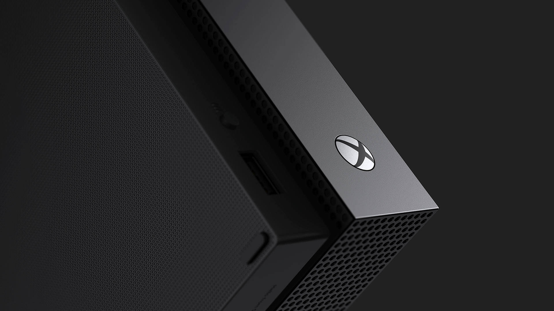 黑色Xbox主機角落，帶有通風孔和發光標誌。