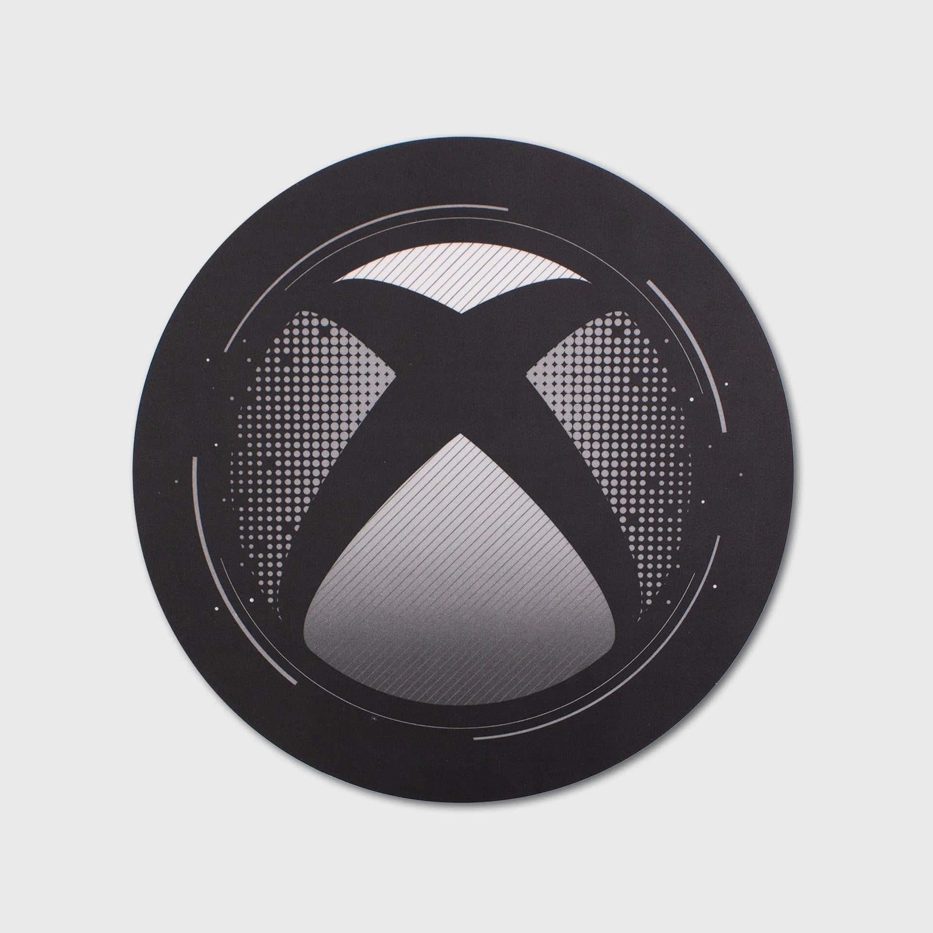 淺灰色背景上帶有漸變和點狀圖案的黑色 Xbox 標誌。