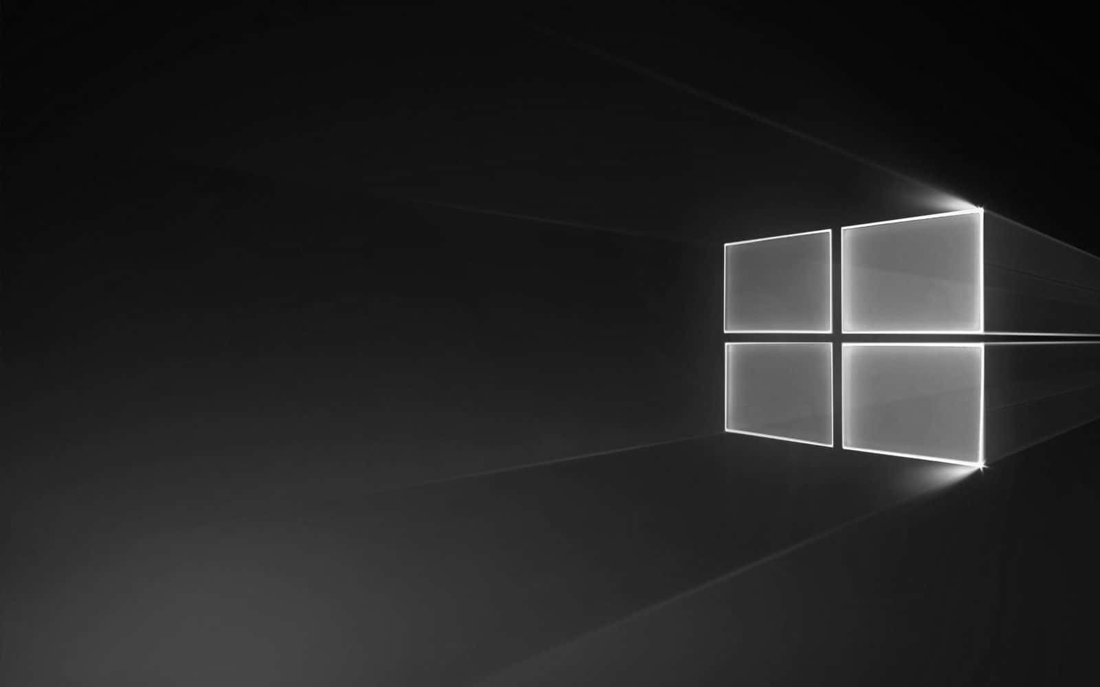 發光的Windows標誌漂浮在黑暗空間中，帶有光線。