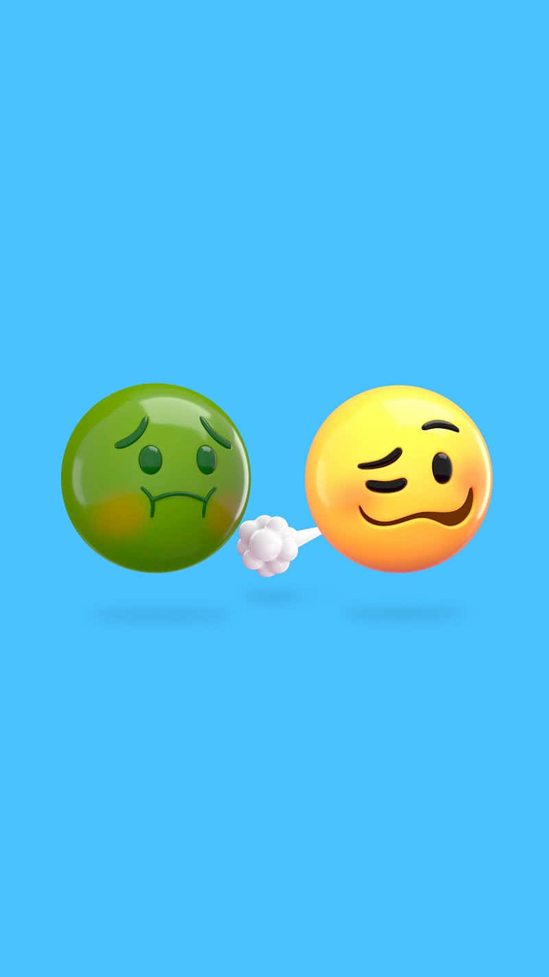  壁紙 — 一個黃色眨眼表情符號在純藍色背景上拳打一個綠色悲傷表情符號。