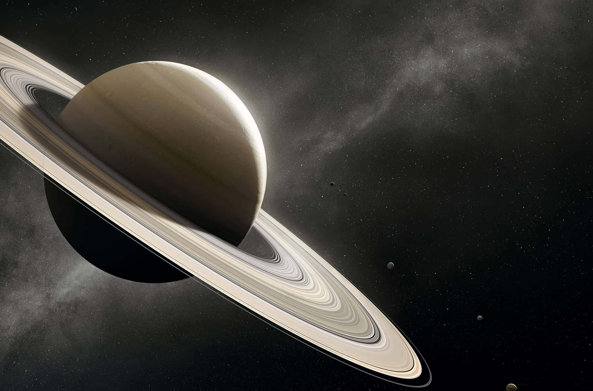  壁紙 — 一顆雄偉的土星帶有複雜的光環，在星光熠熠的宇宙背景中閃耀，遠處還有衛星。