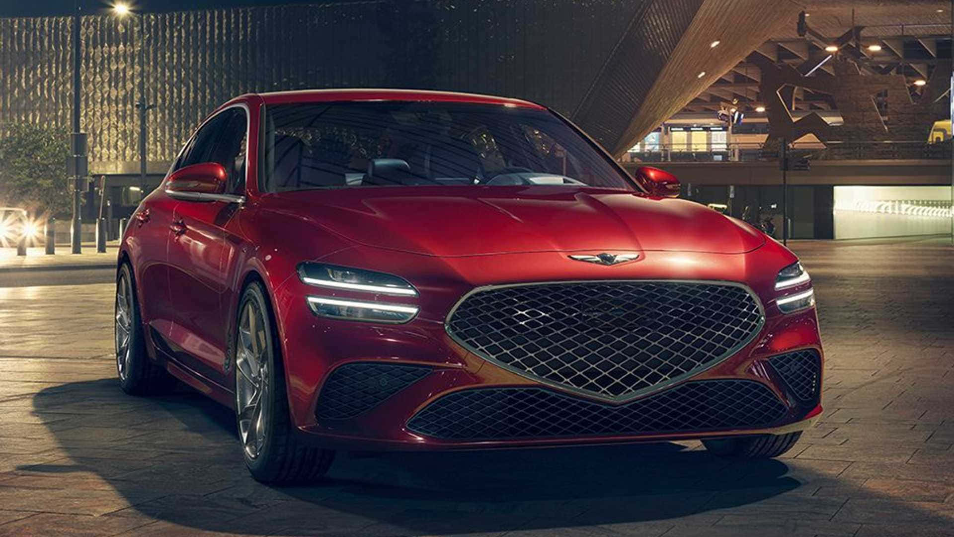 Genesis G70 桌布 壁紙 — 一輛光澤的紅色Genesis G80轎車在夜間城市燈光下，在鋪砌的廣場上閃耀，背景是現代建築。
