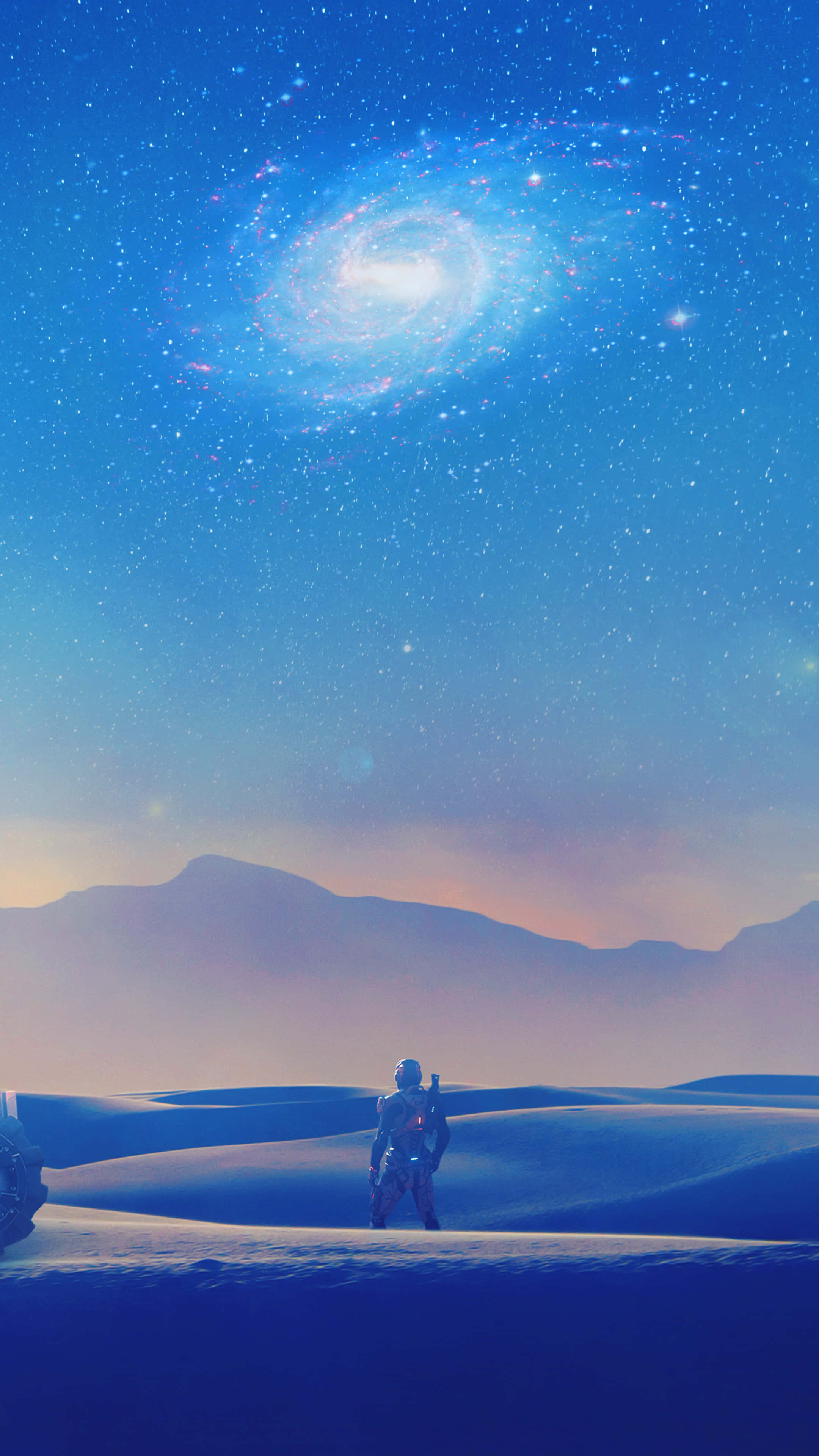 Mass Effect Andromeda 桌布 壁紙 — 一位孤獨的太空人站在廣闊的藍色沙漠中，下方是令人驚嘆的螺旋星系在暮色天空中發光。