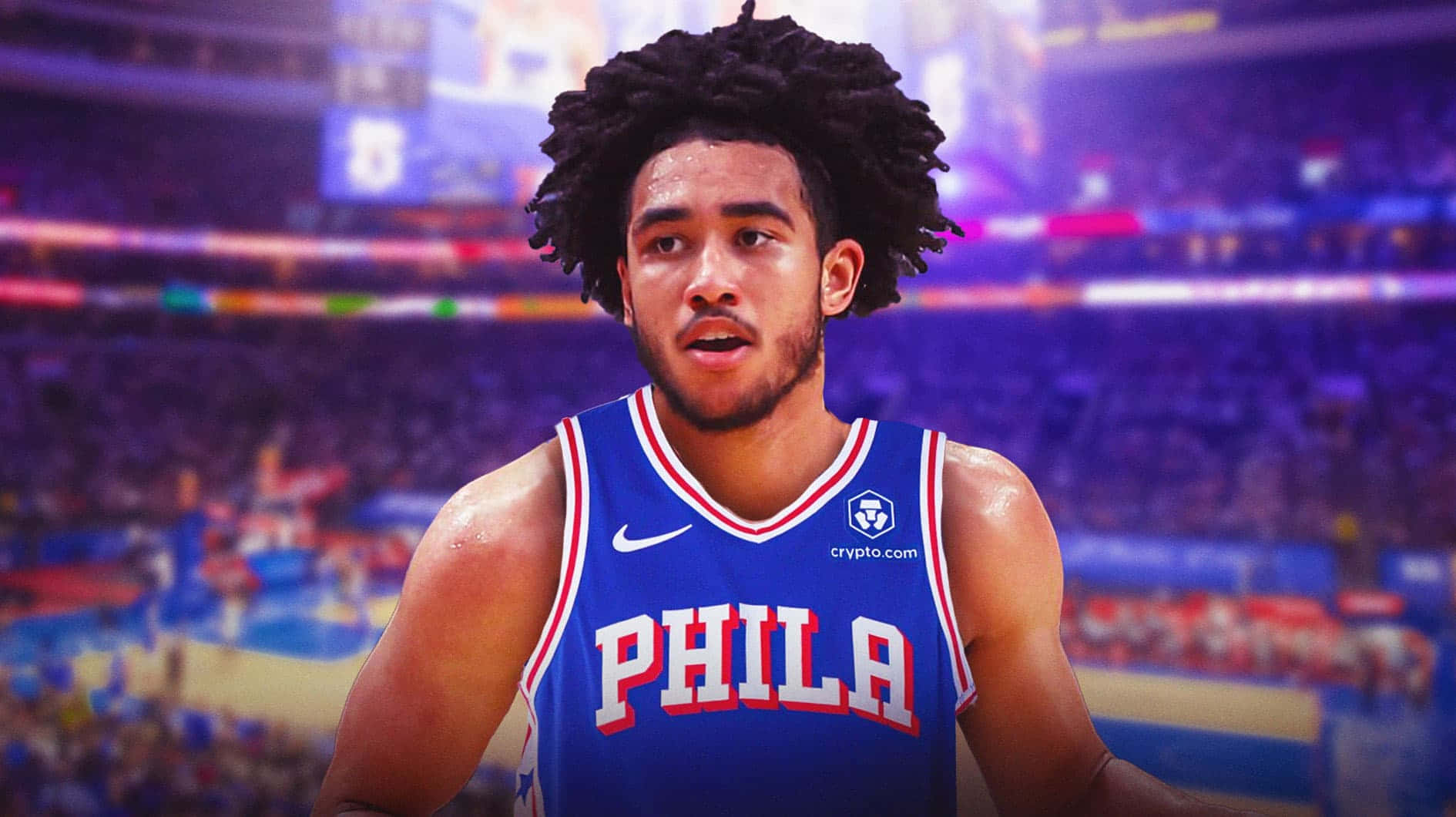  壁紙 — 一位身穿藍色 'PHILA' 球衣、專注的籃球運動員站在充滿活力的場館中，背景是模糊的觀眾和閃爍的燈光。