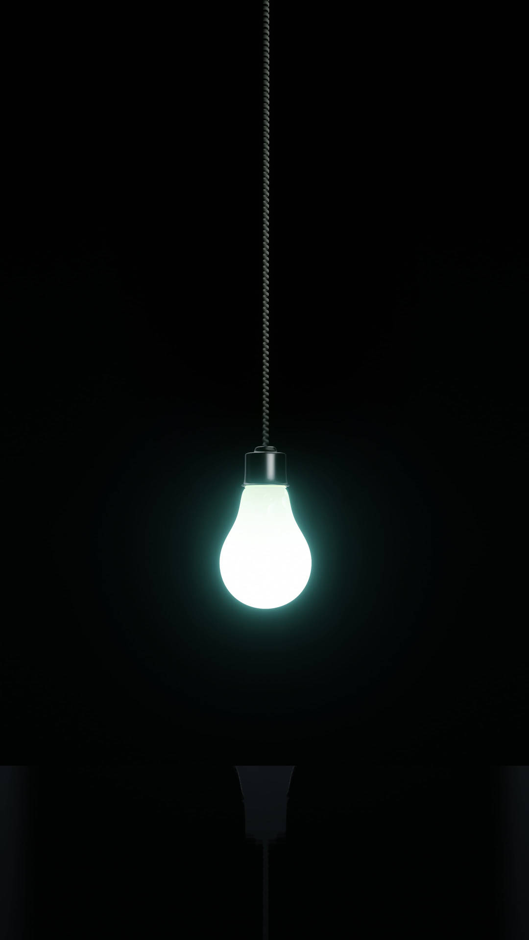 黑暗中一個發光的燈泡用電線懸掛著。