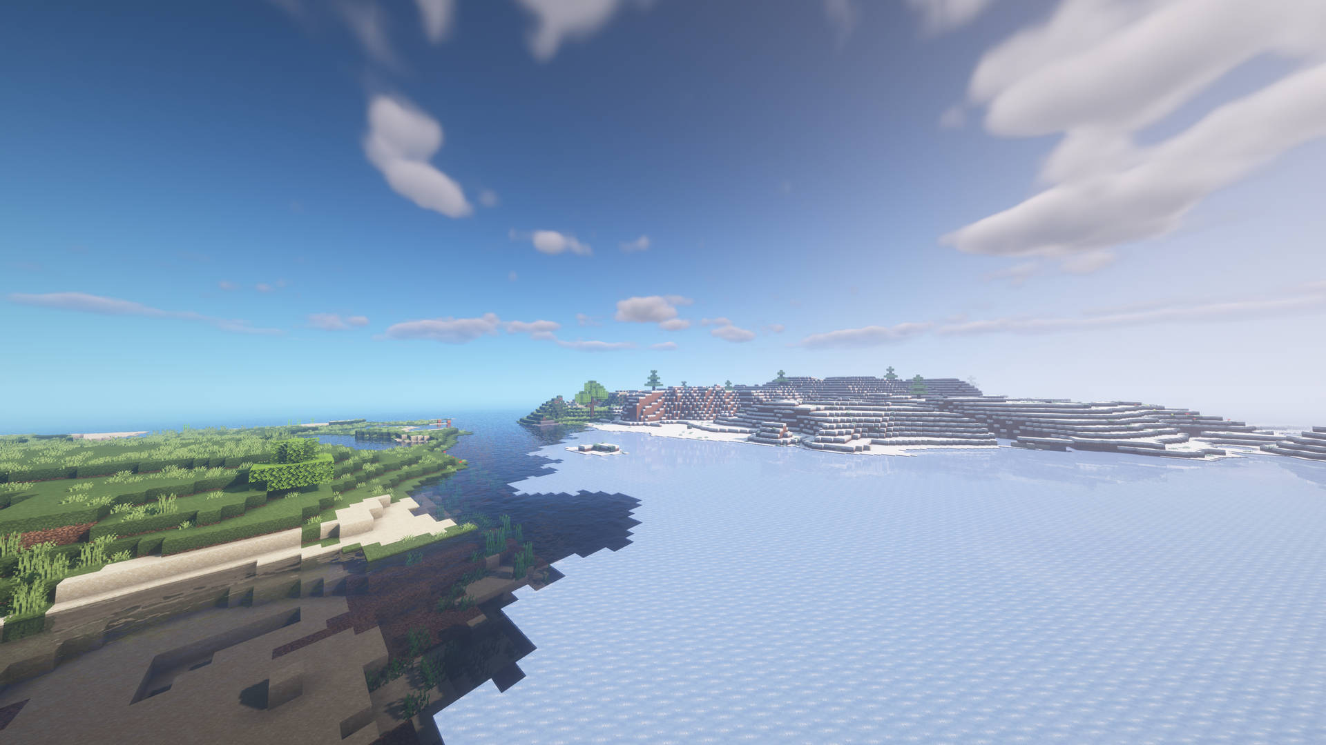 Minecraft村莊位於白雪皚皚的山坡上，旁邊是海洋，天空湛藍