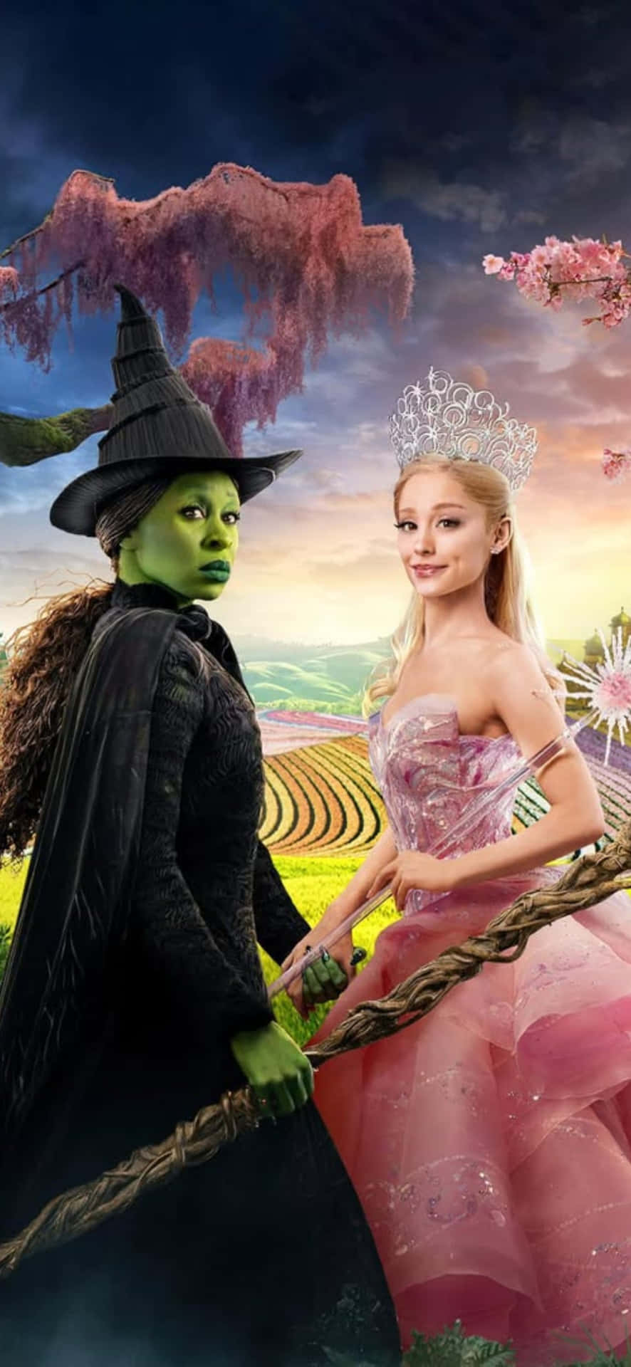  壁紙 — 一個綠色女巫和一個粉紅色公主並肩站在一個超現實的風景中，有漂浮的粉紅色樹木和起伏的山丘。