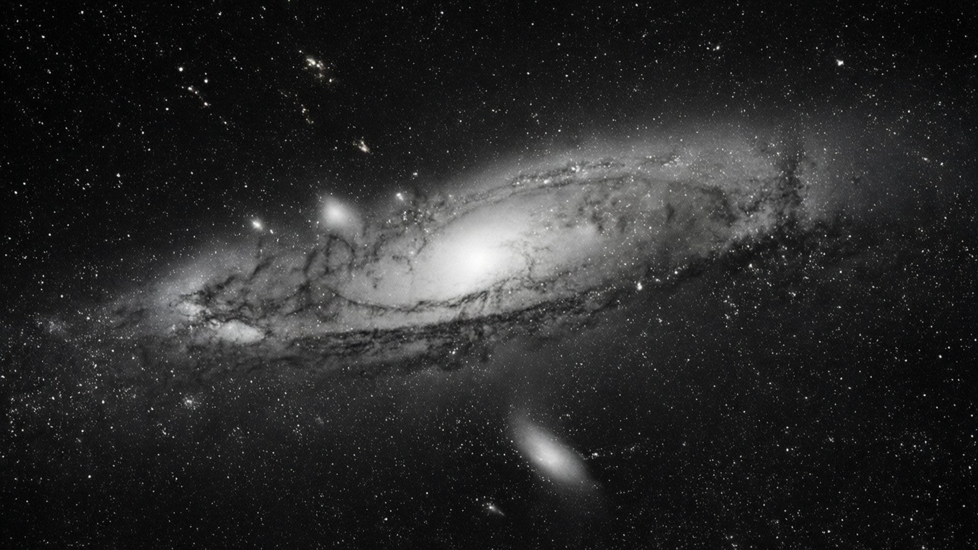 Monochrome Galaxy 壁紙 — 一個宏偉的螺旋星系在深邃的太空中旋轉，呈現出引人注目的黑白宇宙景觀。
